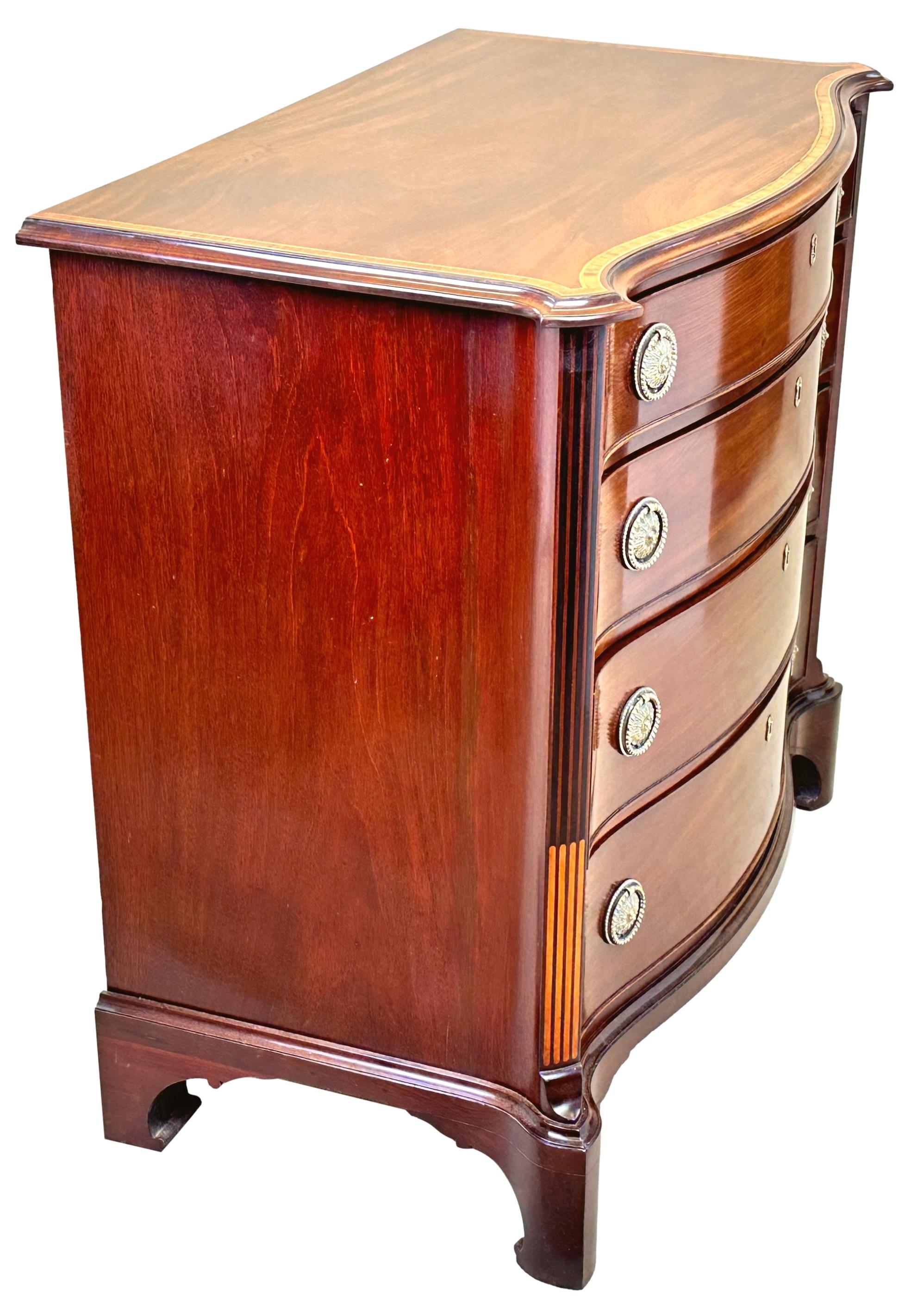 A Delightful And Extremely Good Quality, 18th Century, Georgian Mahogany Serpentine Chest Of Channel Islands Design, Having Superbly Figured Top With Crossbanded Decoration, Over Four Long Drawers With Replacement Brass Handles, Flanked By Canted