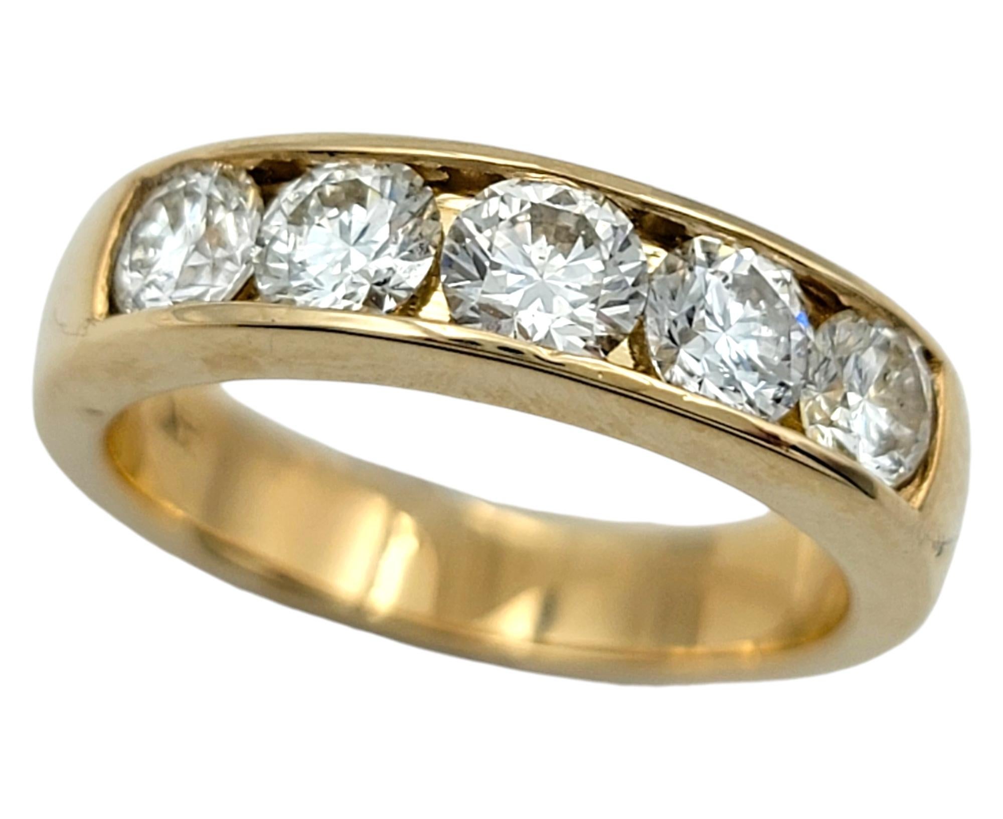 Ring: 6.5 

Discover the timeless elegance of this exquisite band ring, crafted in lustrous 14 karat yellow gold and designed for those who appreciate classic beauty with a touch of brilliance. At the heart of this stunning piece are five dazzling