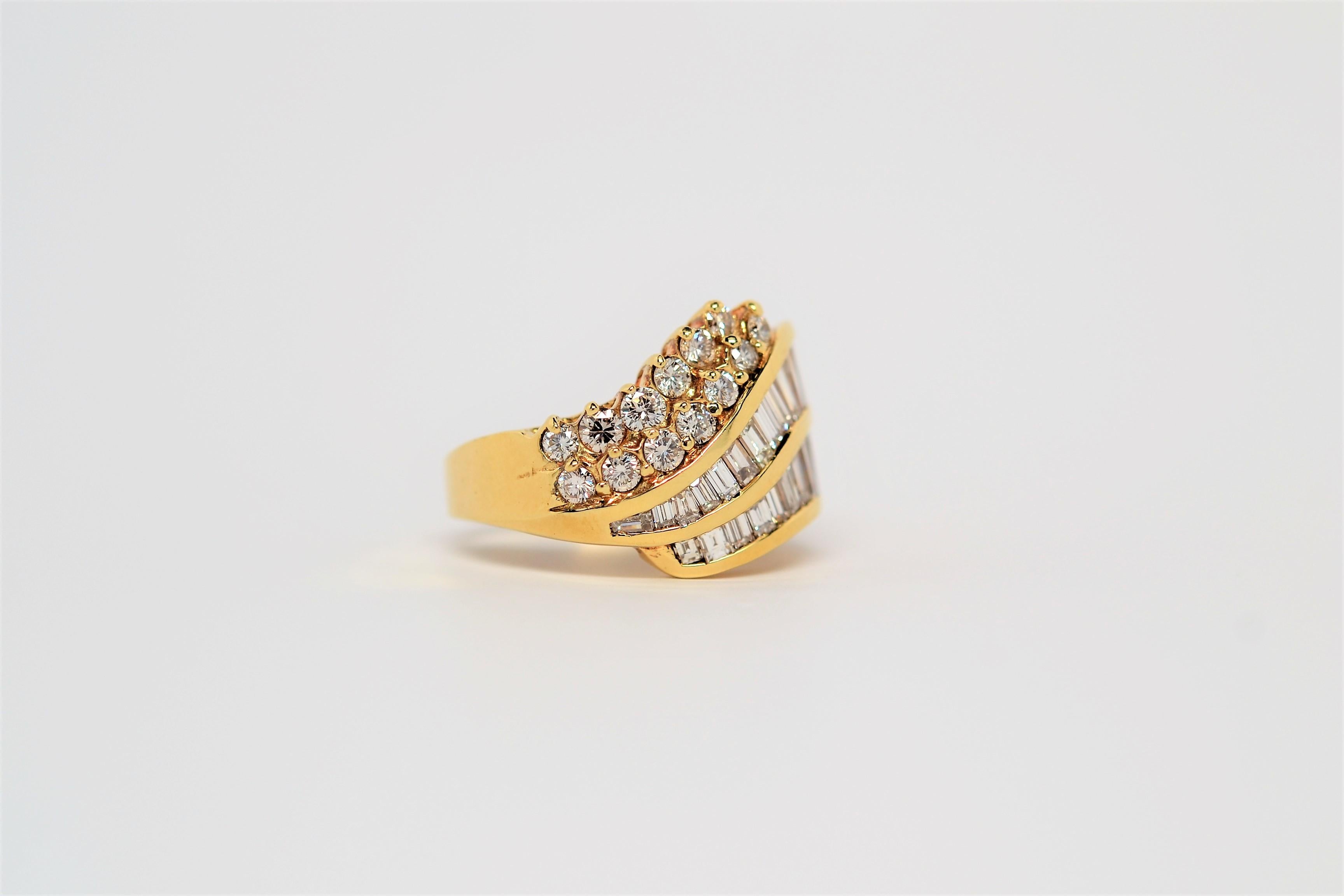 A beautifully made diamond ring set in 18K Yellow Gold with Baguette and Round Brilliant Cut Diamonds. This custom design has four rows of diamonds in a flowing layout and tapers in size from end to end. Two rows of Baguette Diamonds are channel set