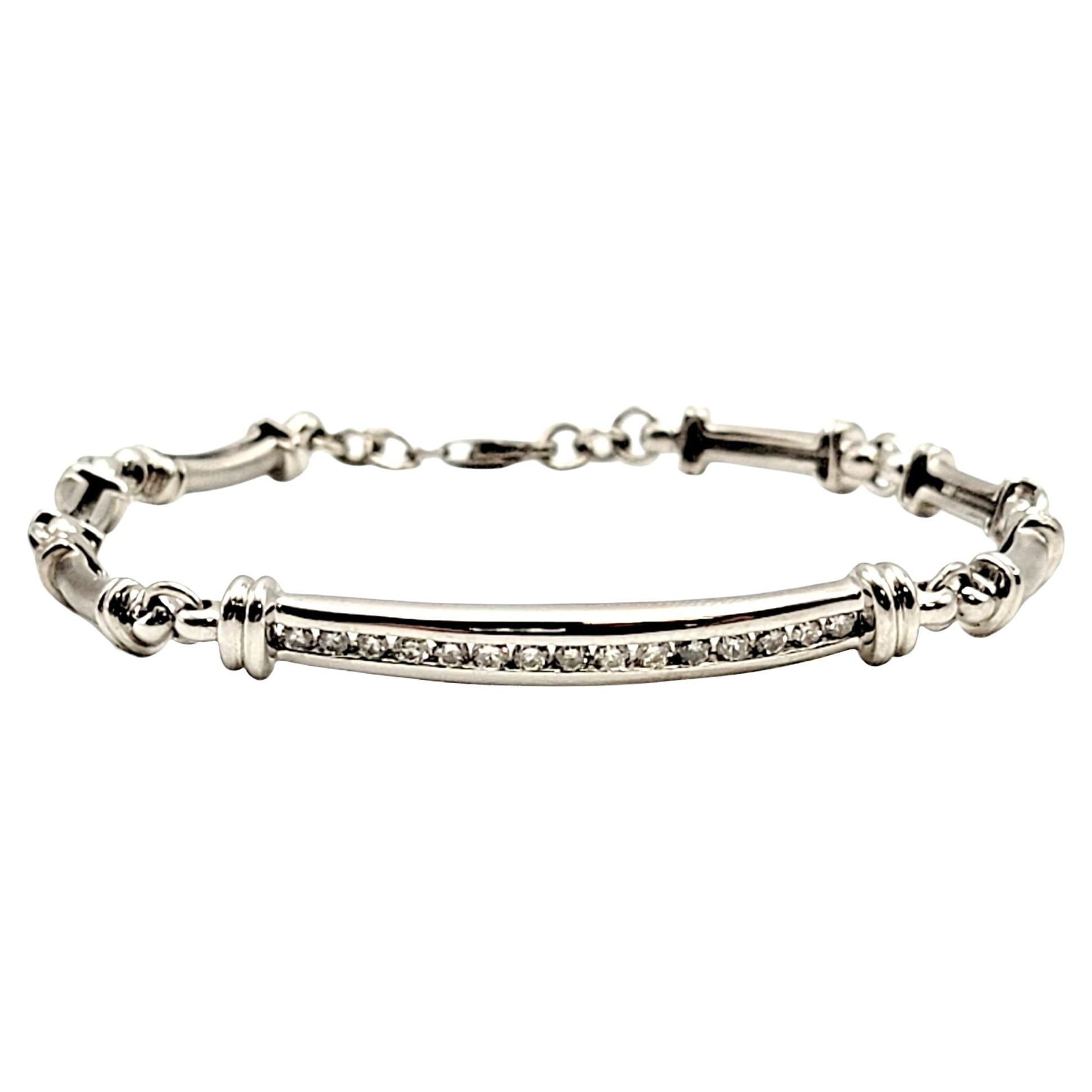 Elegant and modern bracelet sparkling with 15 icy white channel set natural diamonds. An elongated polished white gold bar link sits at the center, surrounded by brushed gold links. Sleek and sophisticated, this bracelet goes with just about