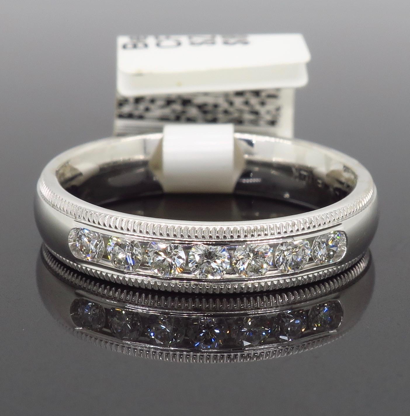 Channel set Round Brilliant Cut diamond band with filigree detail crafted in 14K white gold.

Diamond Carat Weight: Approximately .32CTW
Diamond Cut: Round Brilliant Cut
Color: Average  G-H
Clarity: Average VS
Metal: 14K White Gold
Marked/Tested: