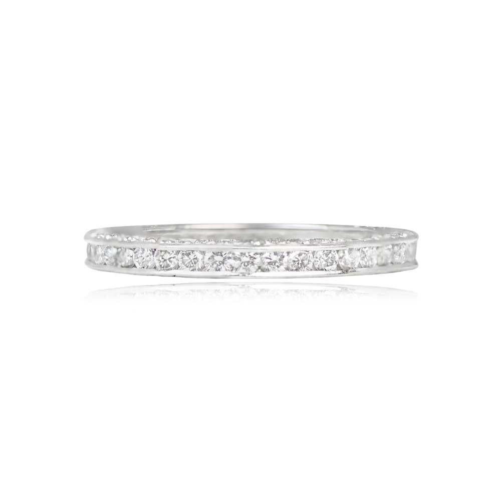This captivating wedding band boasts an antique-style design, featuring a breathtaking row of channel-set diamonds encircling the band in eternity. Additionally, two rows of diamonds adorn the top and bottom, enhancing the allure of the gorgeous