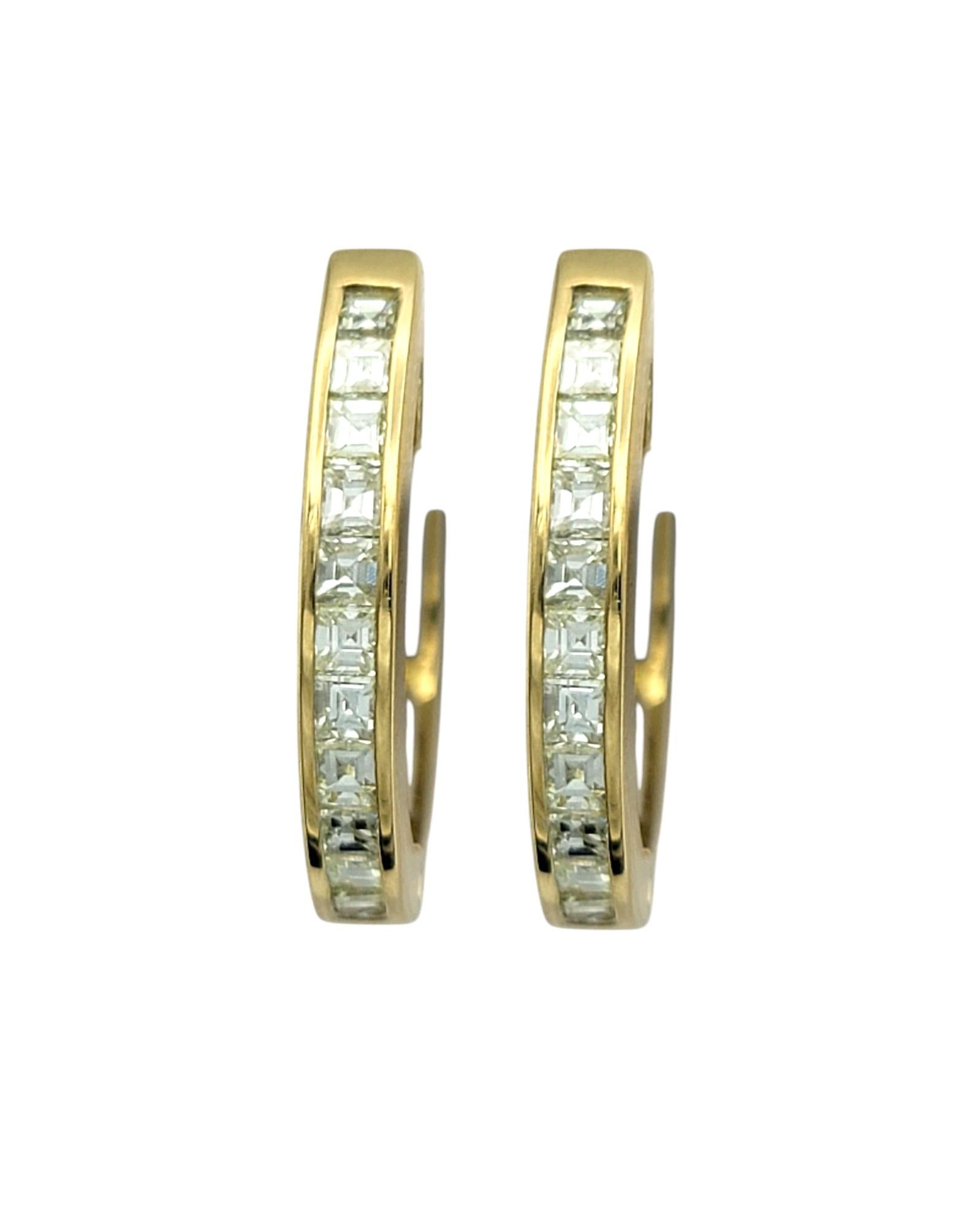 Discover the refined elegance of these diamond hoop earrings, beautifully crafted in 18 karat yellow gold. A row of square emerald-cut diamonds adorns each hoop, offering a sophisticated sparkle with a sleek, modern aesthetic. Their timeless design