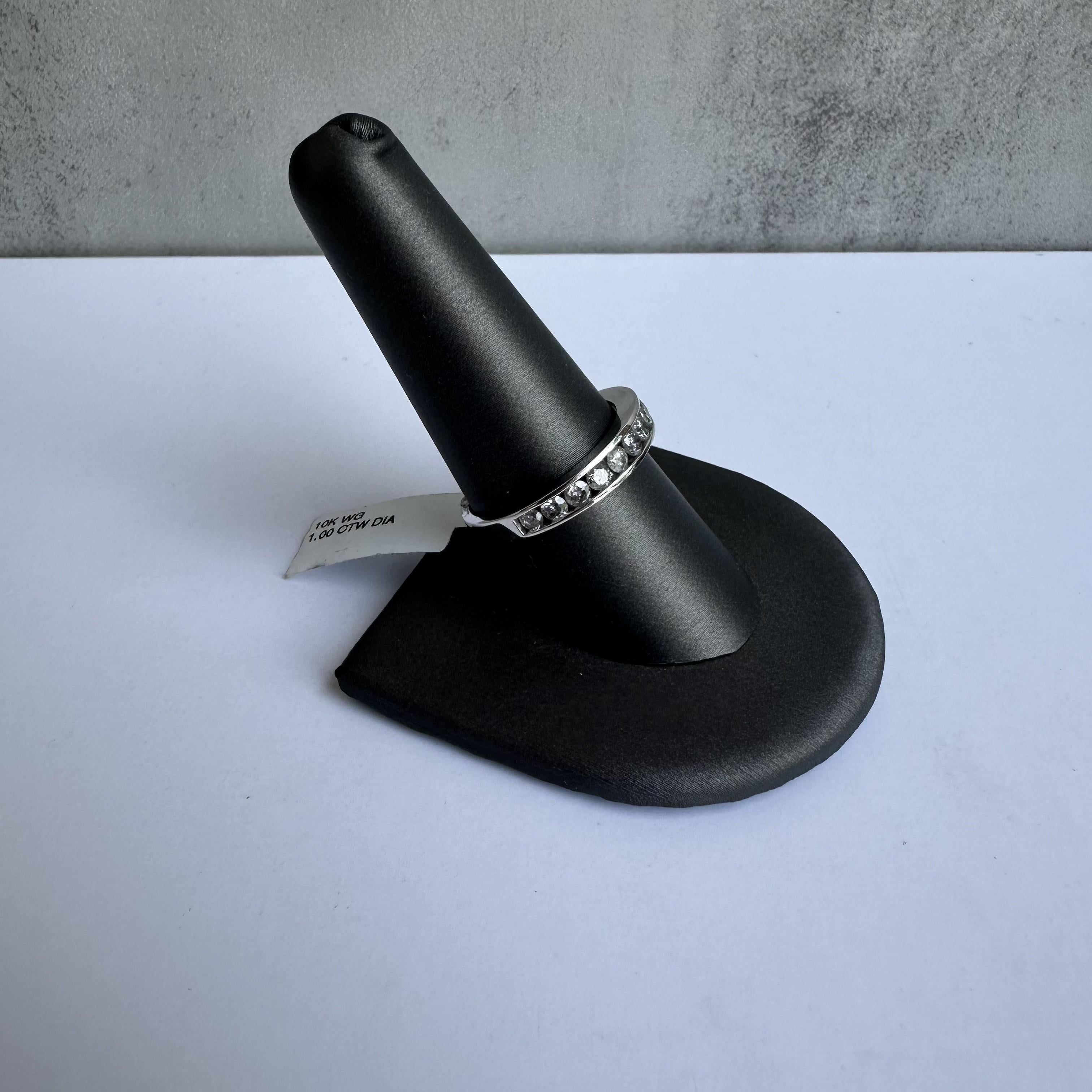 Add a touch of sophistication to your jewelry collection with this stunning Channel Set Natural Diamond Ring in 10kt White Gold. Featuring 1 carat of natural round diamonds in a classic channel setting, this ring combines timeless beauty with modern