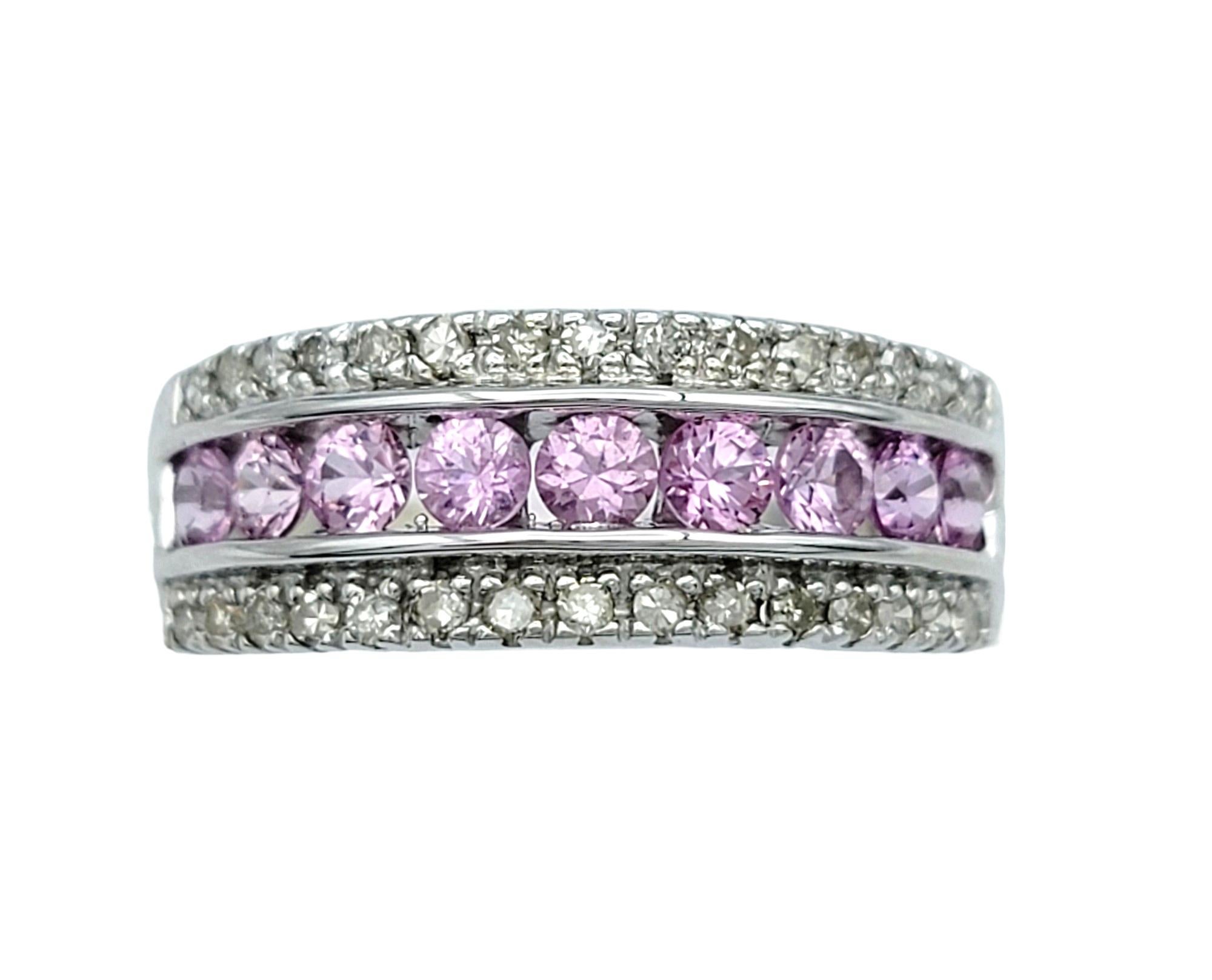 Ring Size: 7

This elegant pink sapphire and diamond band ring is a beautful work of art. Set in lustrous 14 karat white gold, the band features alternating pink sapphires and dazzling diamonds, creating a captivating display of color and