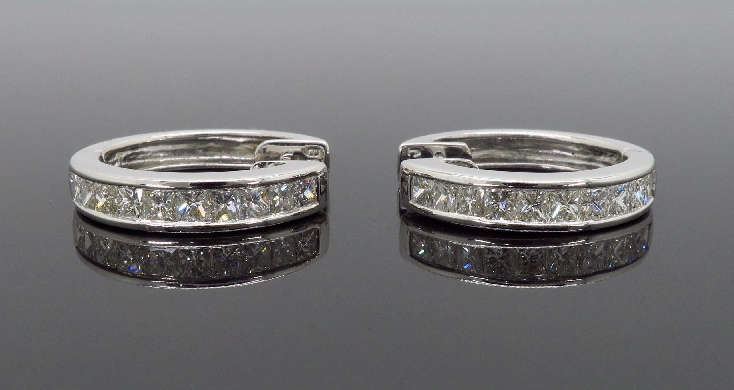 Channel set princess cut diamond hoop earrings crafted in 18k white gold. 

Diamond Carat Weight: Approximately 1.06CTW 
Diamond Cut: Princess Cut Diamonds
Color: Average G-J
Clarity: Average VS
Metal: 18K White Gold
Marked/Tested: Stamped “BKJ 750