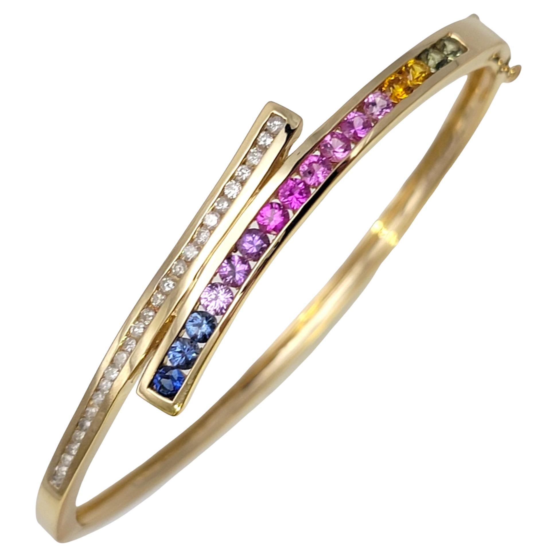 Shown here is an absolutely gorgeous bypass bracelet bursting with color and sparkle. Crafted with the utmost artistry, this incredible piece is adorned with a captivating combination of natural sapphires and diamonds, set in the luxurious 14 karat