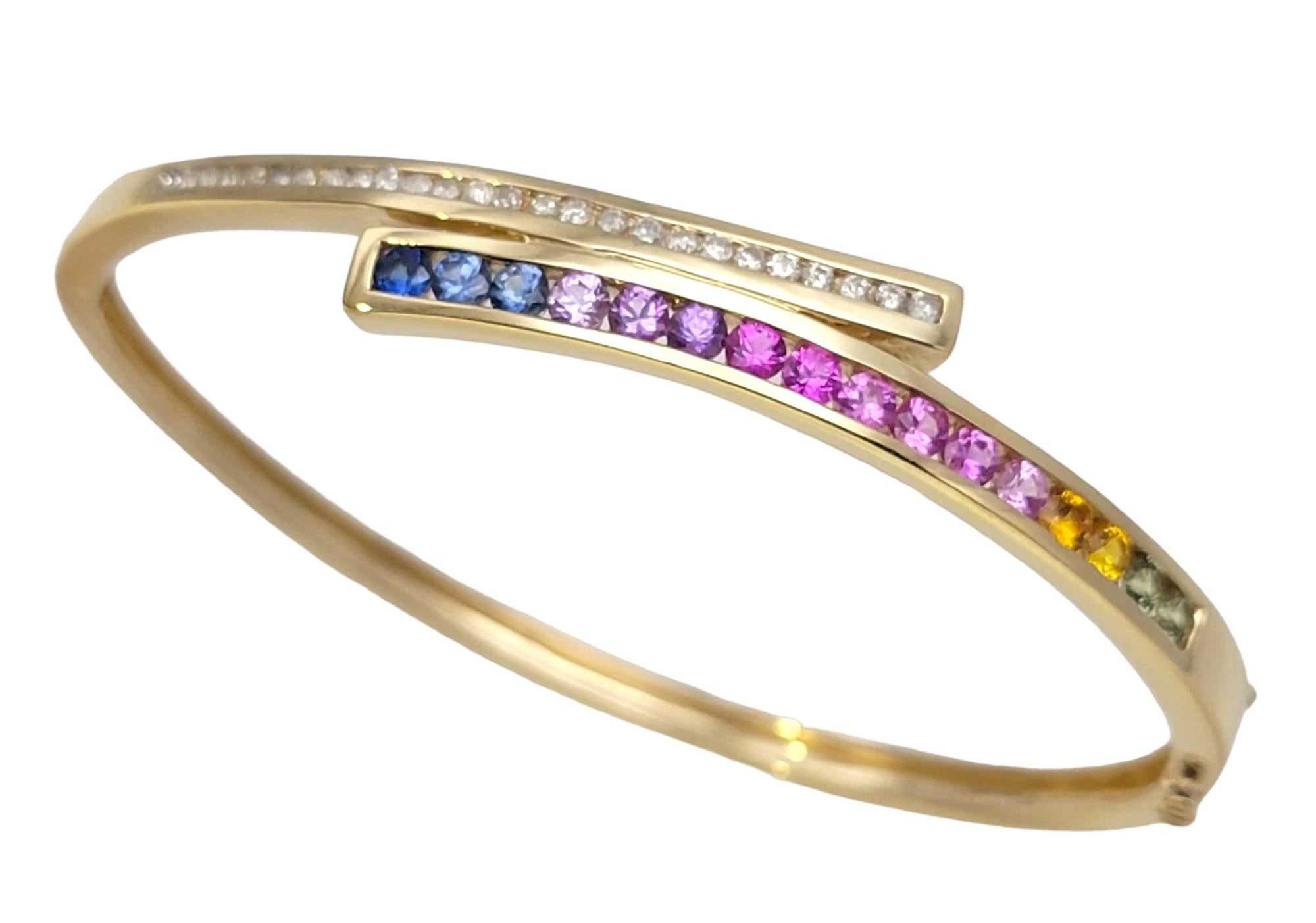 Contemporary  Channel Set Rainbow Sapphire and Diamond Bypass Bangle Bracelet in Yellow Gold For Sale