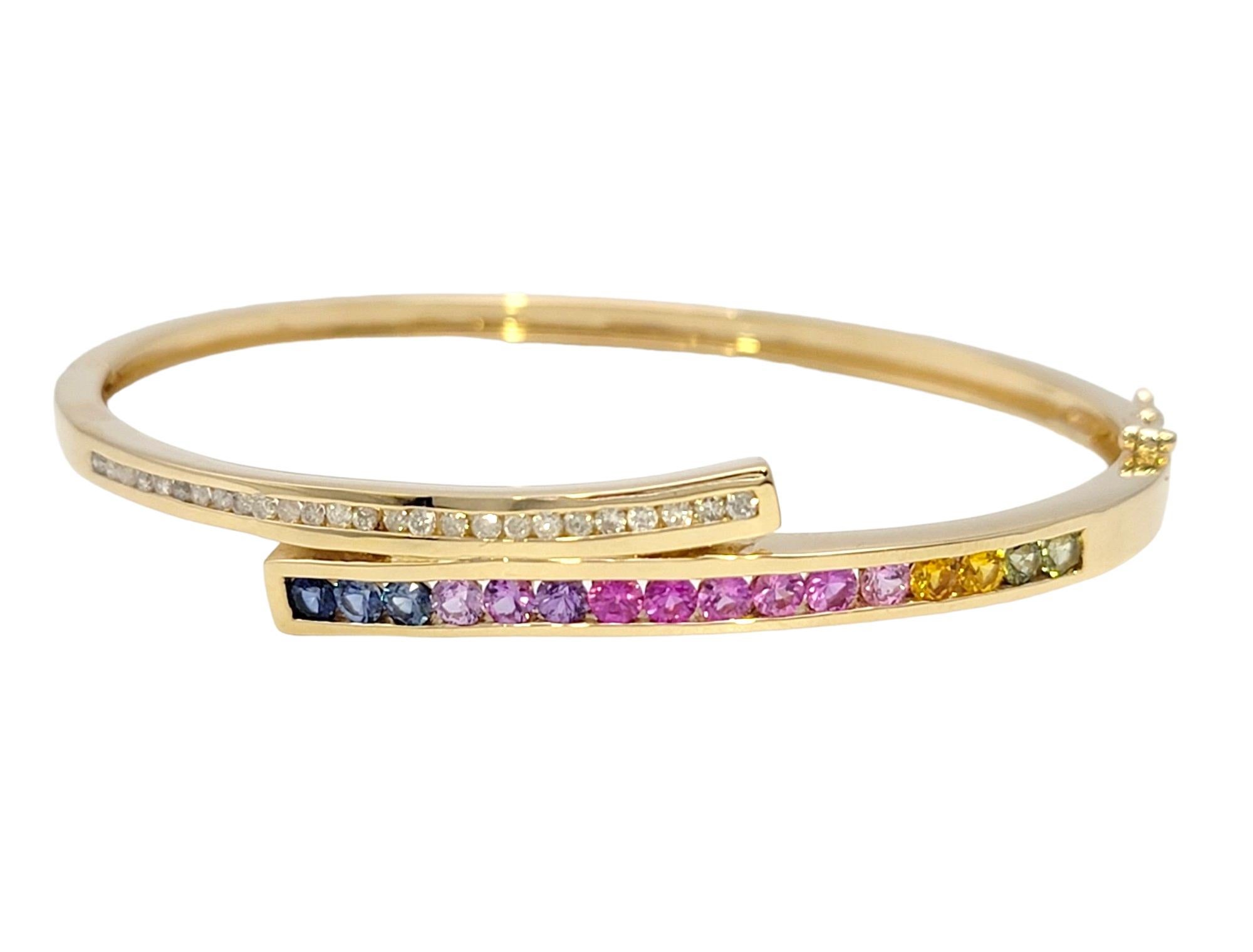 Contemporary  Channel Set Rainbow Sapphire and Diamond Bypass Bangle Bracelet in Yellow Gold For Sale