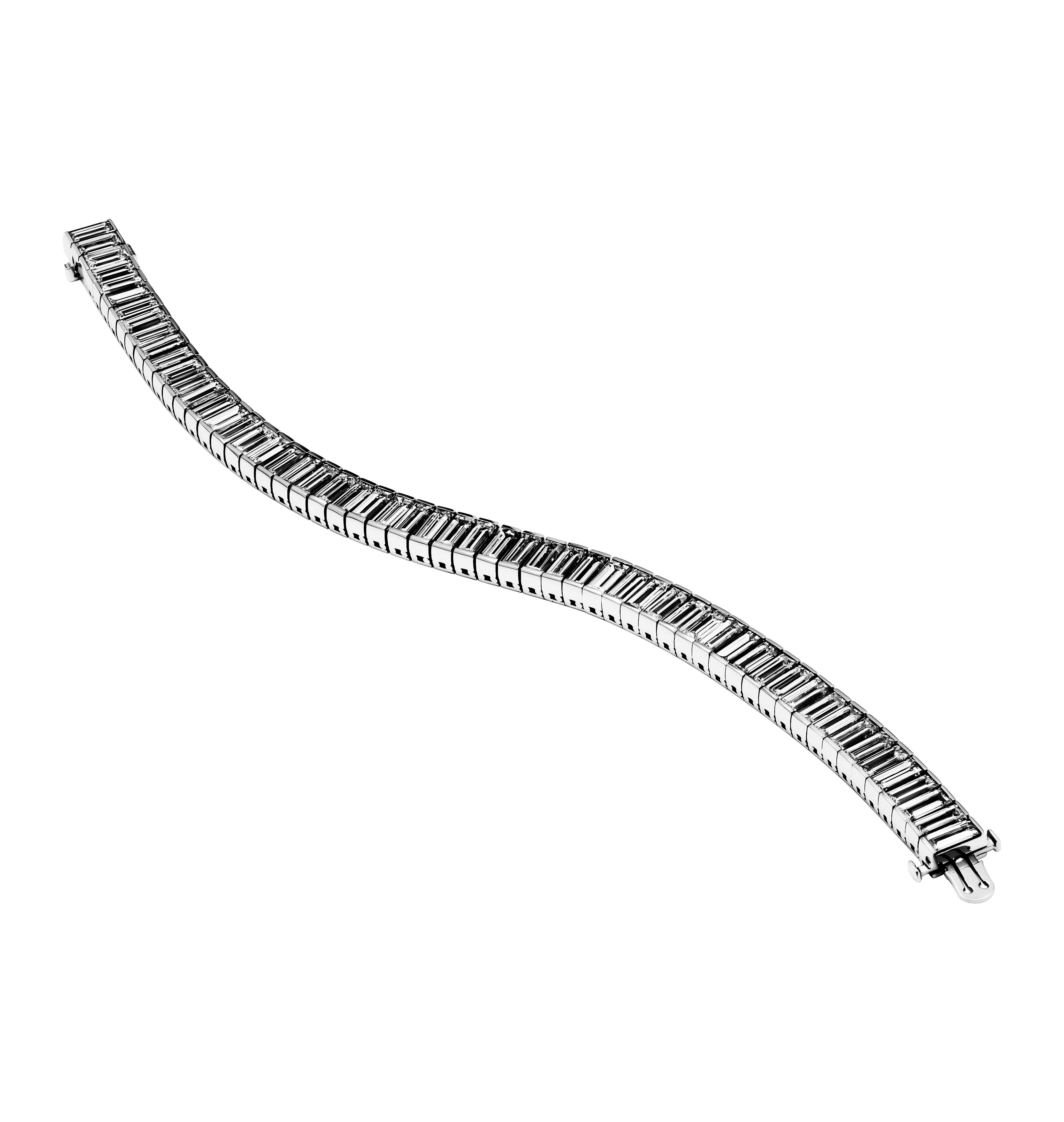 Indulge in the luxurious elegance of this Channel Set Tennis Bracelet, masterfully crafted in 950 platinum. This stunning piece features 57 exquisite natural baguette diamonds, meticulously selected for their exceptional D-G color and IF-VS2
