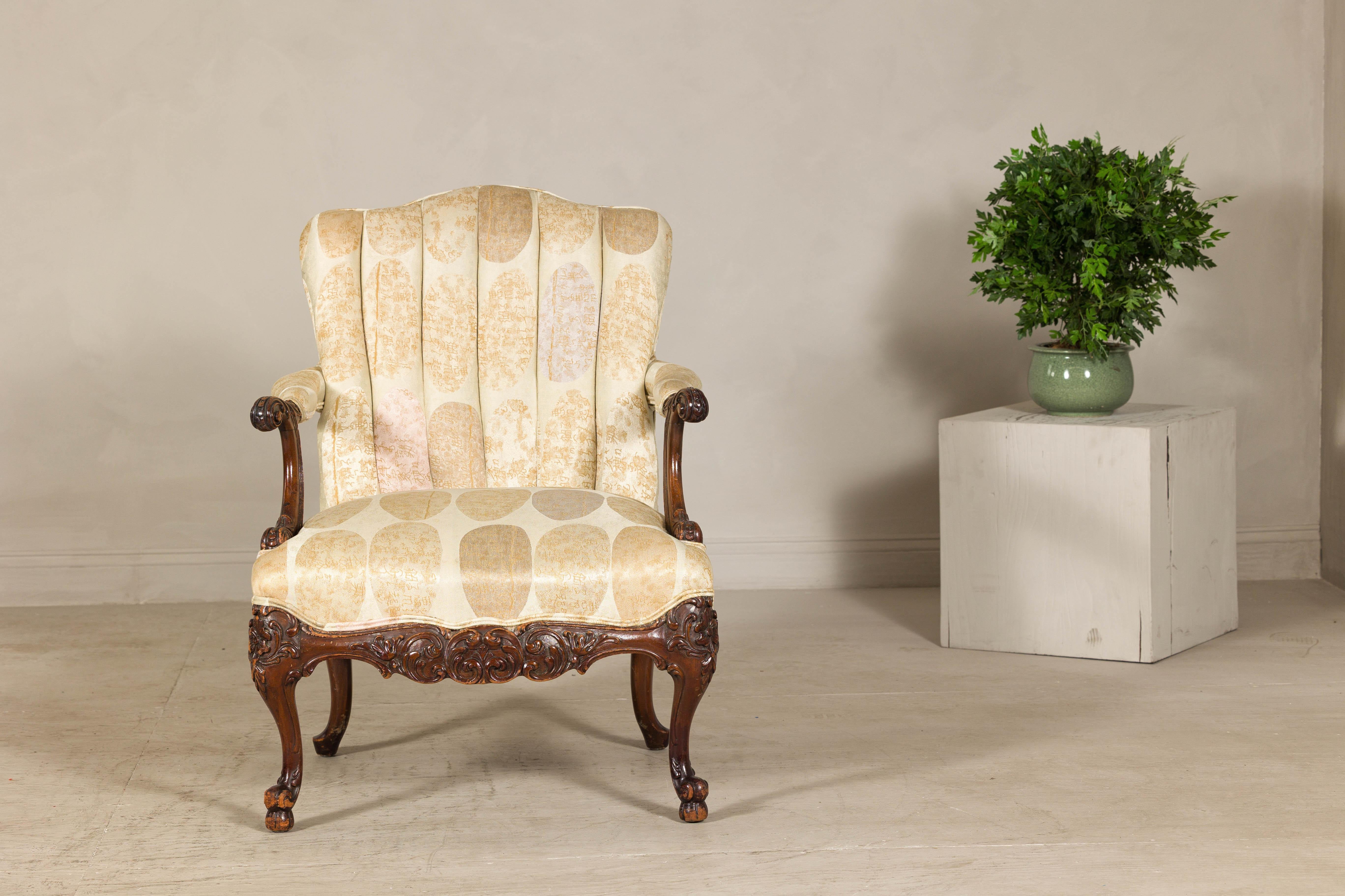 Combining the elegance of a Louis XV-style silhouette with a distinctly modern flair, this vintage upholstered armchair stands out with its bold calligraphy-patterned fabric. Crafted with an elegant silhouette, the chair features a gently arched and