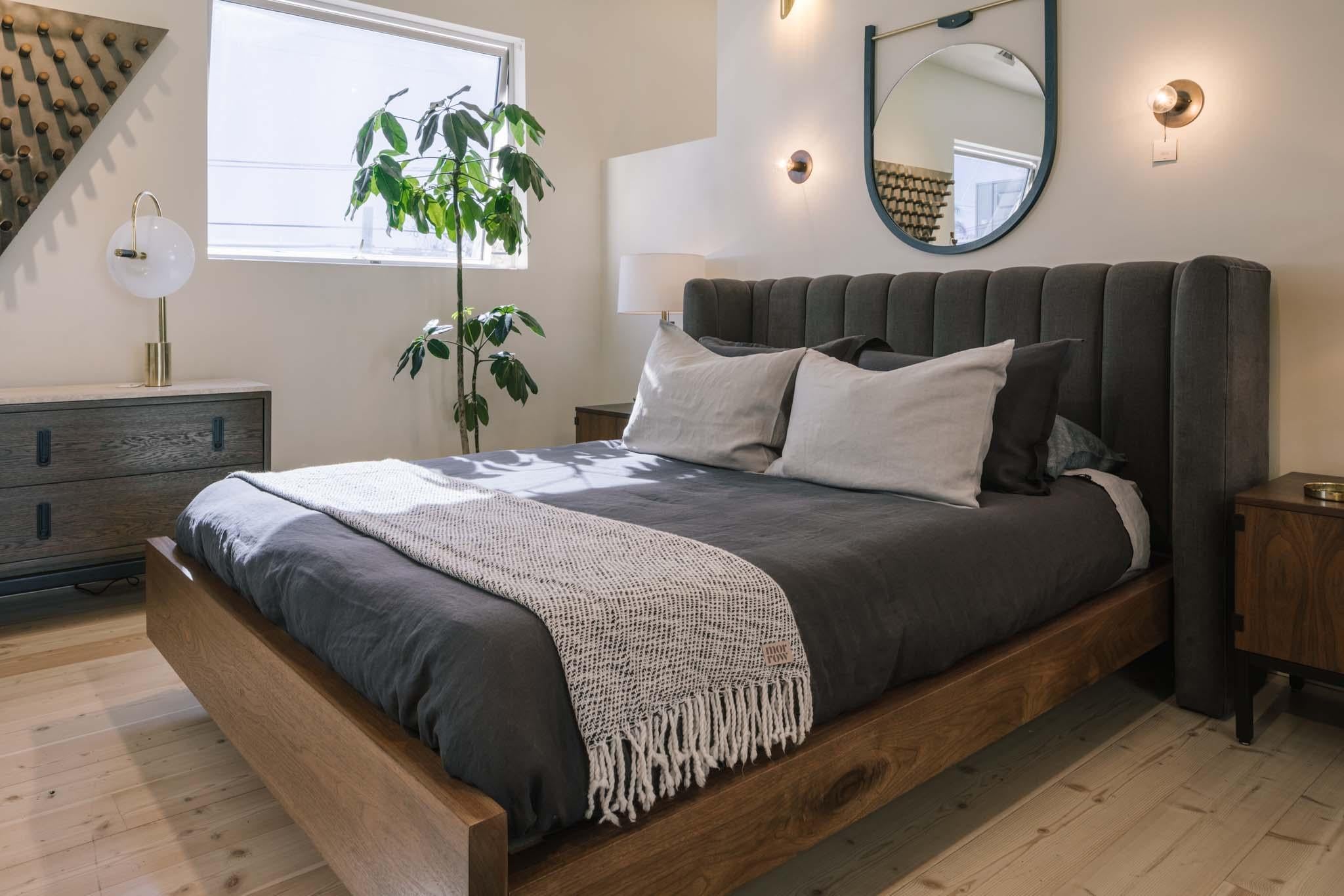The Isherwood bed features a plinth base made of American walnut or white oak and a channel tufted shelter headboard. Slats are provided. 

The Lawson-Fenning Collection is designed and handmade in Los Angeles, California.