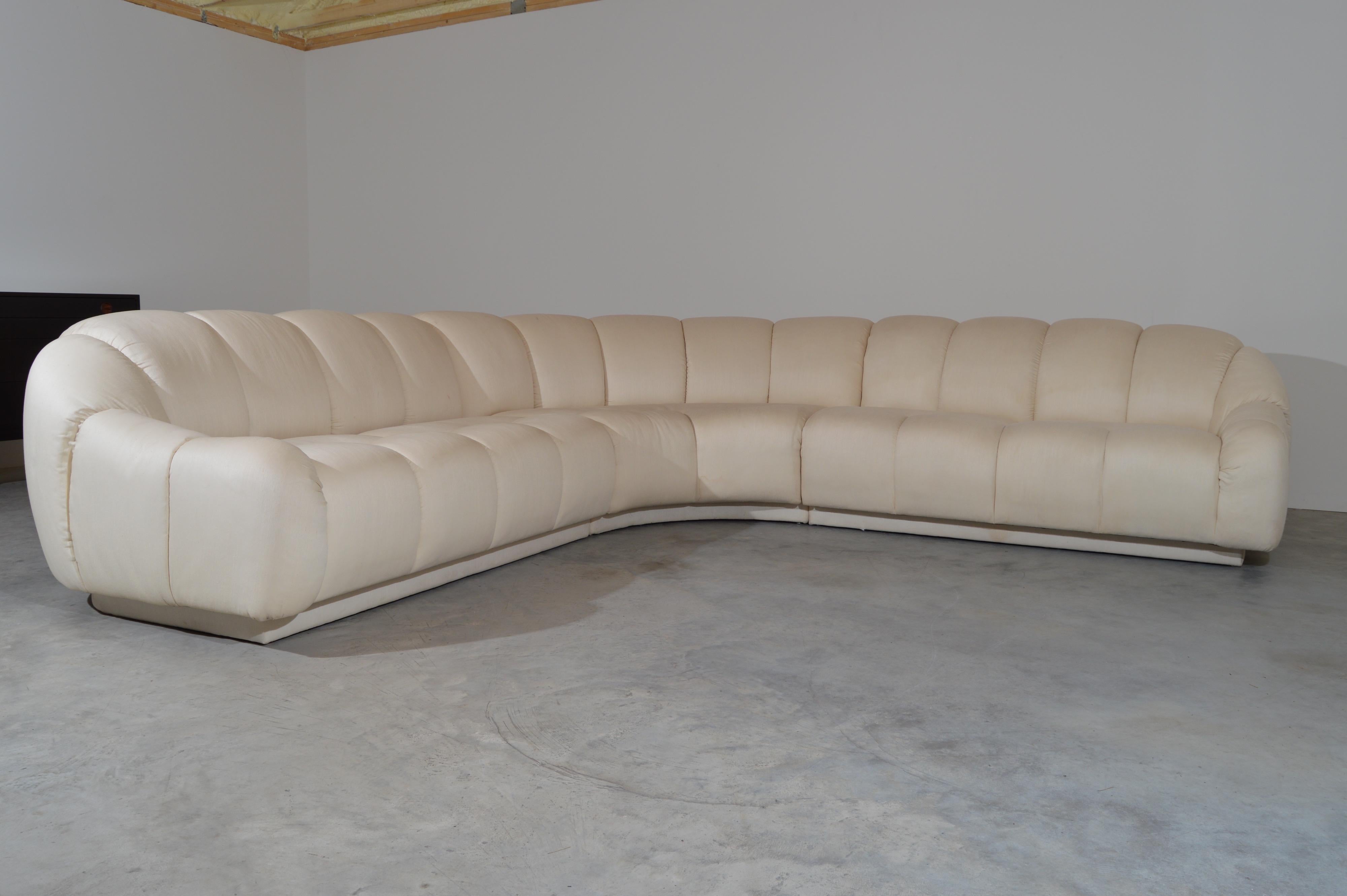 3 Piece sectional sofa in the style of Steve Chase having thick tufted channel backrest with overstuffed seats. Upholstered in a silky cotton poly blend. 
Center section 30x74x39 HWD SH 17”
Left & Right Sections 30x60x40” HWD SH 17”
Total width