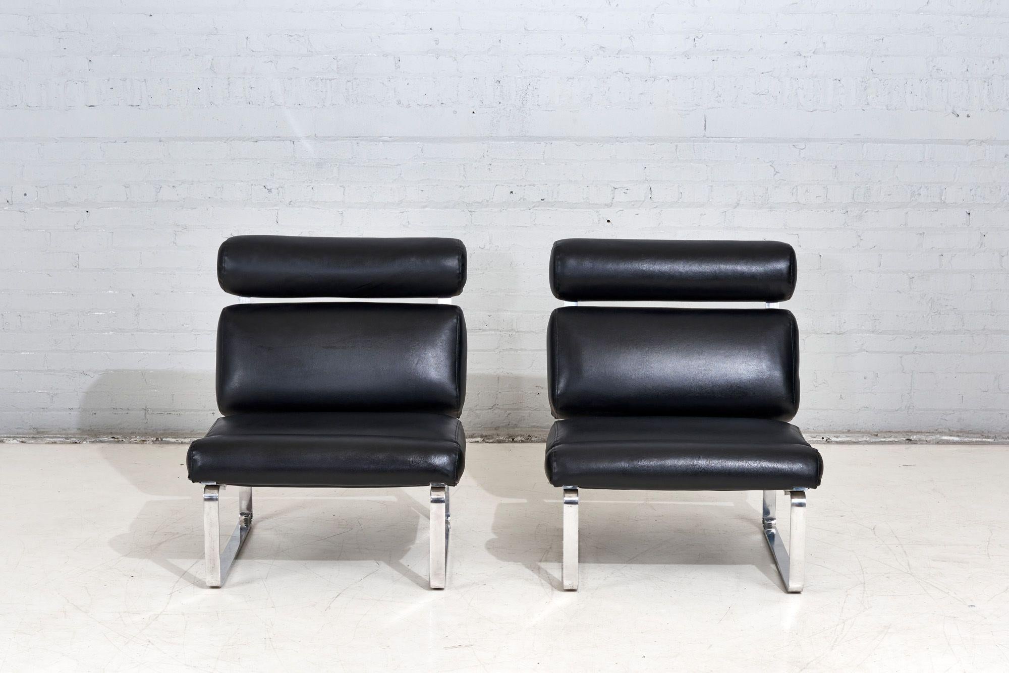 Channel Upholstered Slipper lounge chairs with  polished aluminum flat bar in black naugahyde