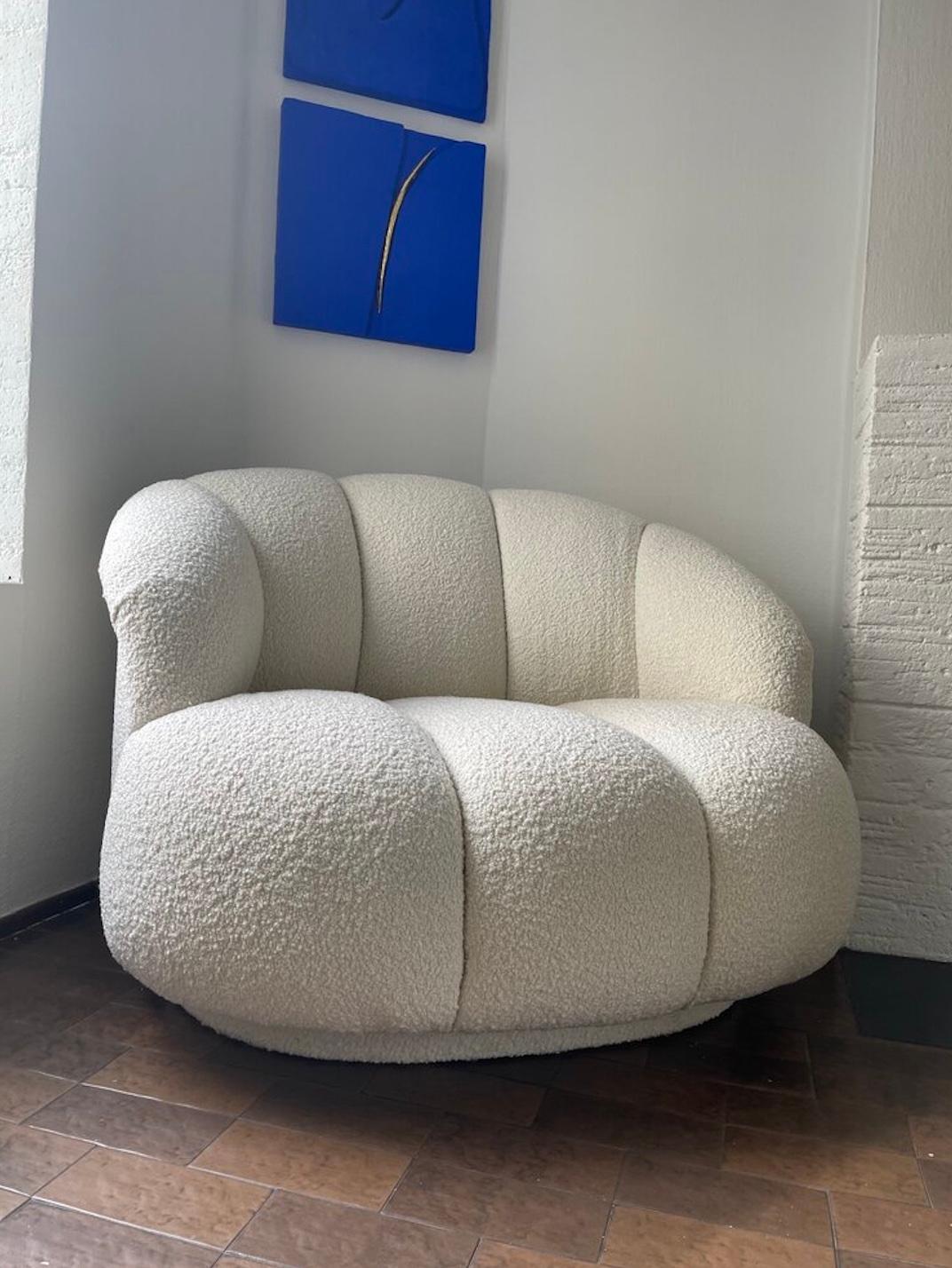 A plush vintage channeled chair with curved lines and newly reupholstered in an Ivory Italian Boucle. USA, 1980s. This chair sits very comfortably.