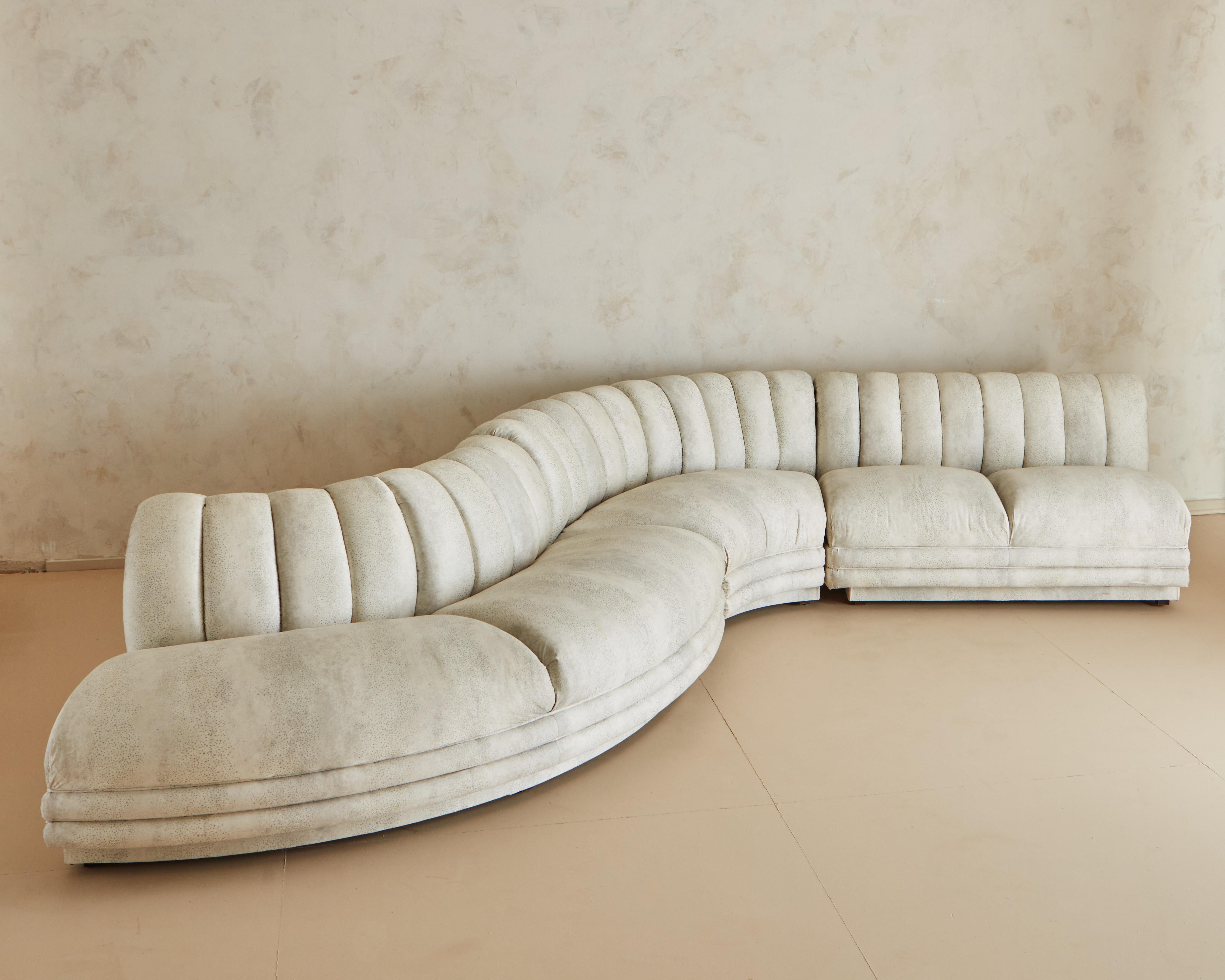 A three part sectional sofa in a luxurious serpentine shape featuring a channeled back and channeled face. 

Dimensions: Each section measures the following: 

Measures: 50L x 32D x 29H
65Lx 32D x 29H
82L x 32D x 29 H.