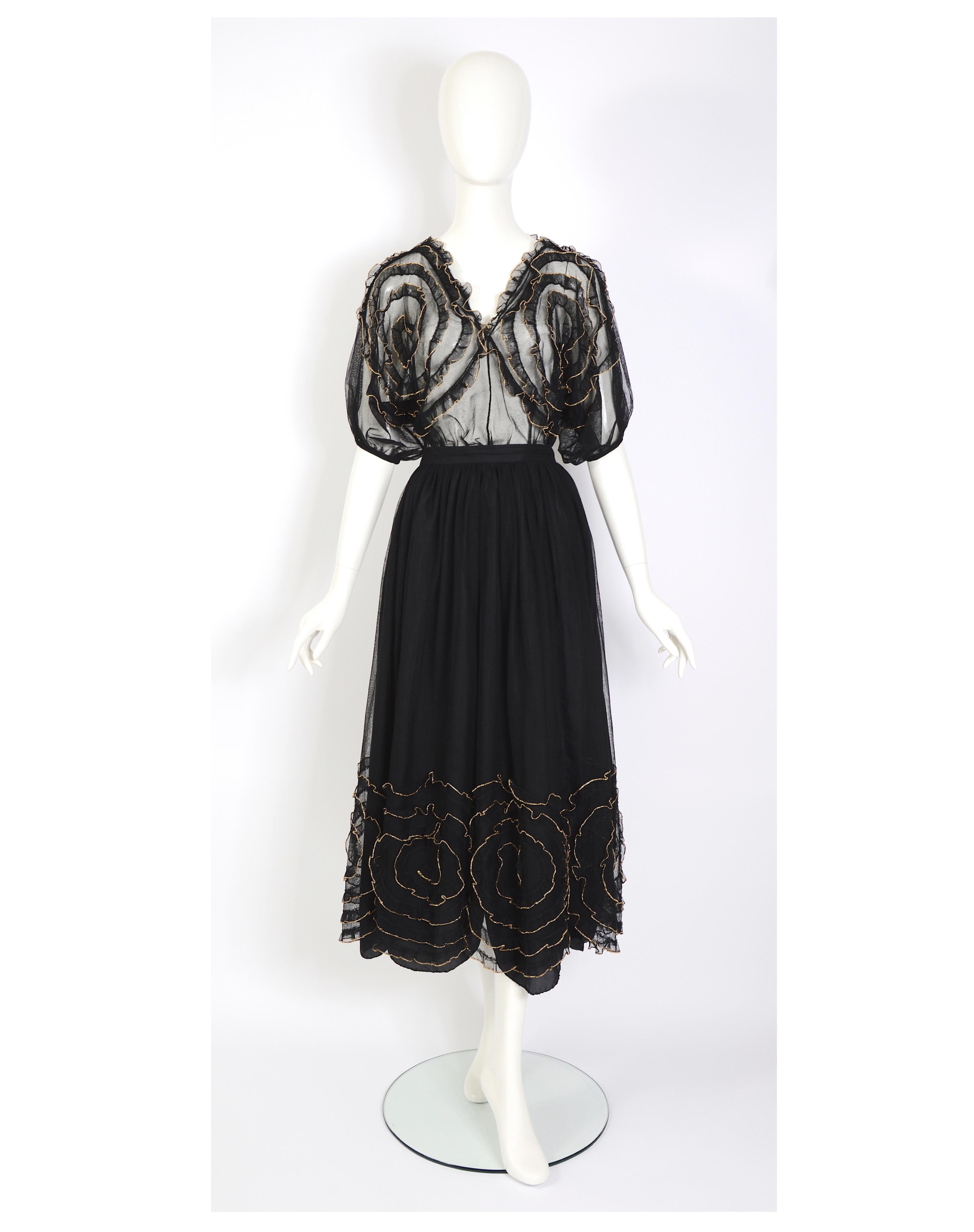 Verlaine Vintage is delighted to offer a stunning Chantal Thomass vintage ensemble consisting of a black tulle skirt and a matching top. Adorned with exquisitely crafted gold-edged flowers, this outfit is a true work of art. The top features these