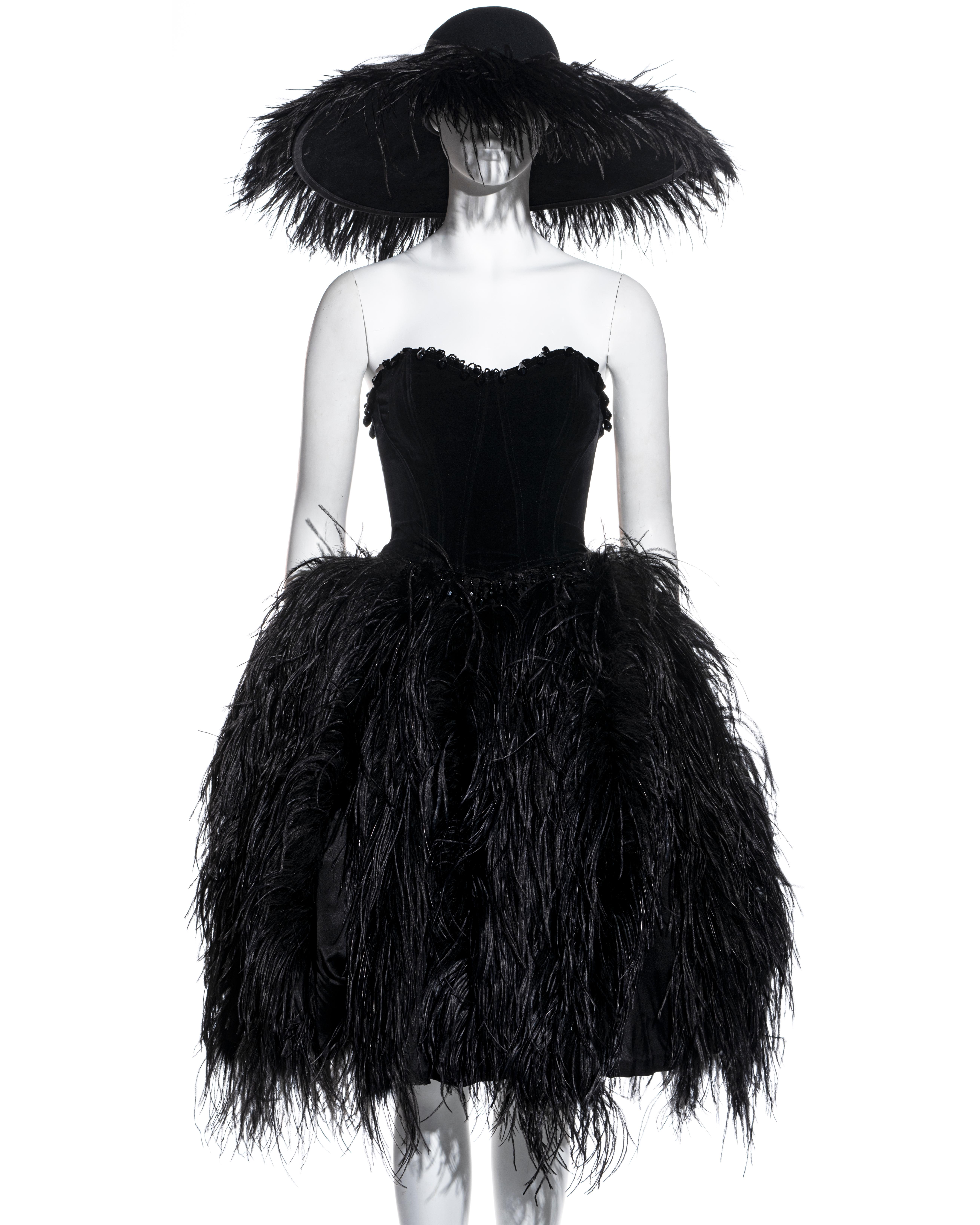 ▪ Chantal Thomass black ostrich feather 3 piece evening ensemble 
▪ Felt saucer hat with ostrich feathers around the brim 
▪ Velvet bustier corset with beaded tassel trim 
▪ Bell skit with ostrich feather and built-in tulle petticoat skirt
▪ Size