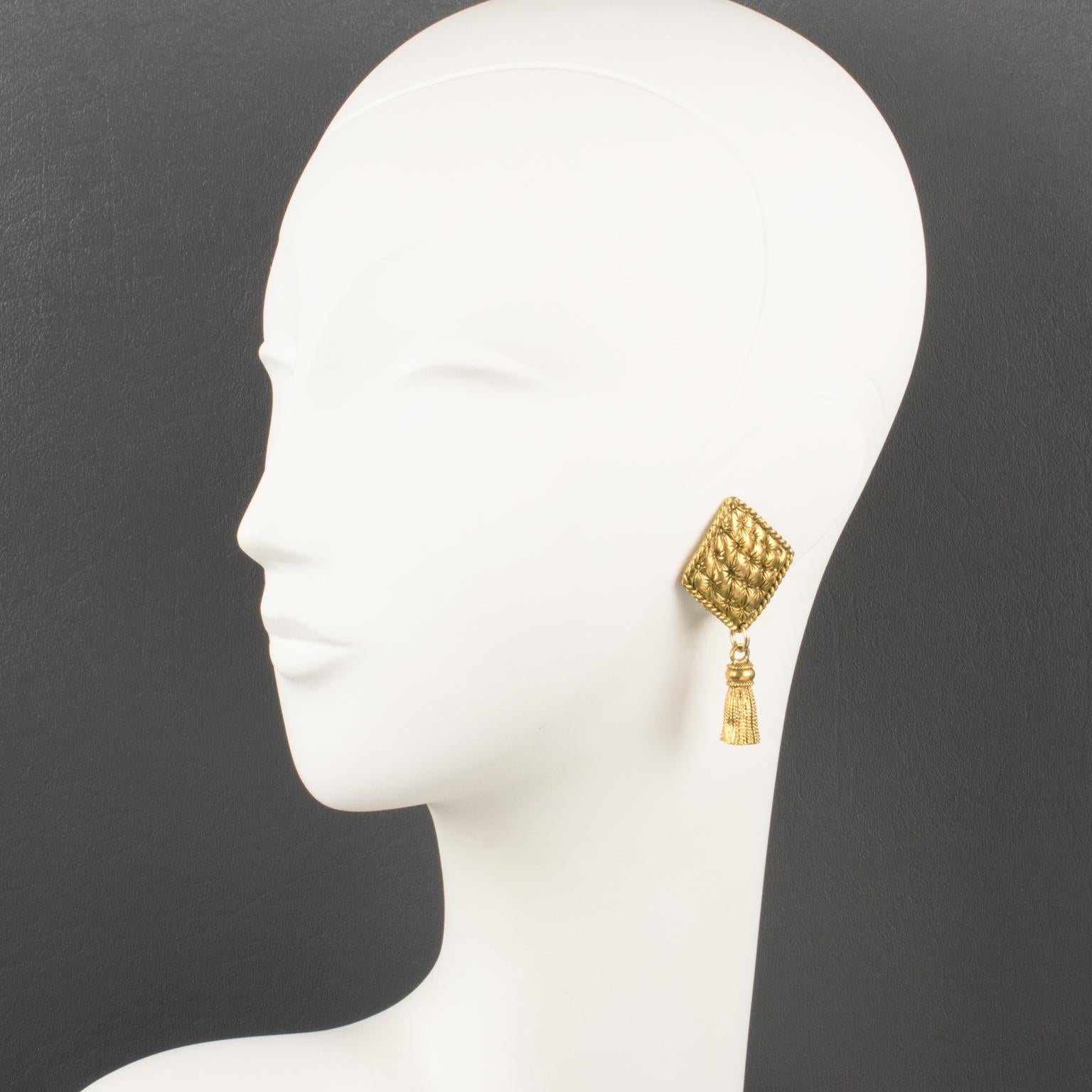 These elegant French designer Chantal Thomass Paris clip-on earrings feature a dangling shape with gilt metal quilted diamond shape fittings that complement a tassel. The pieces are marked on the underside with the company logo. 
Measurements: 1.19