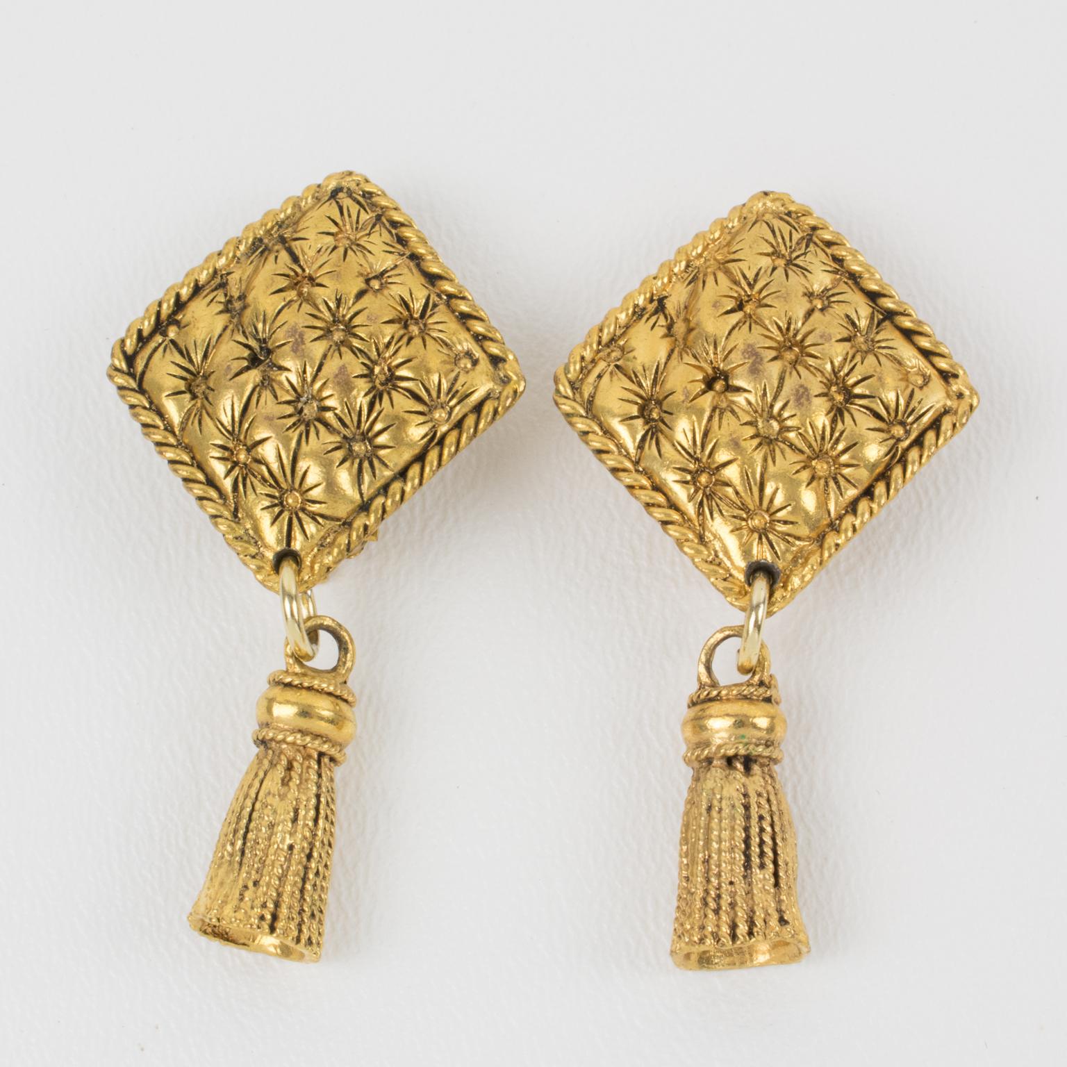 These elegant French designer Chantal Thomass Paris clip-on earrings feature a dangling shape with gilt metal quilted diamond shape fittings that complement a tassel. The pieces are marked on the underside with the company logo. 
Measurements: 1.19