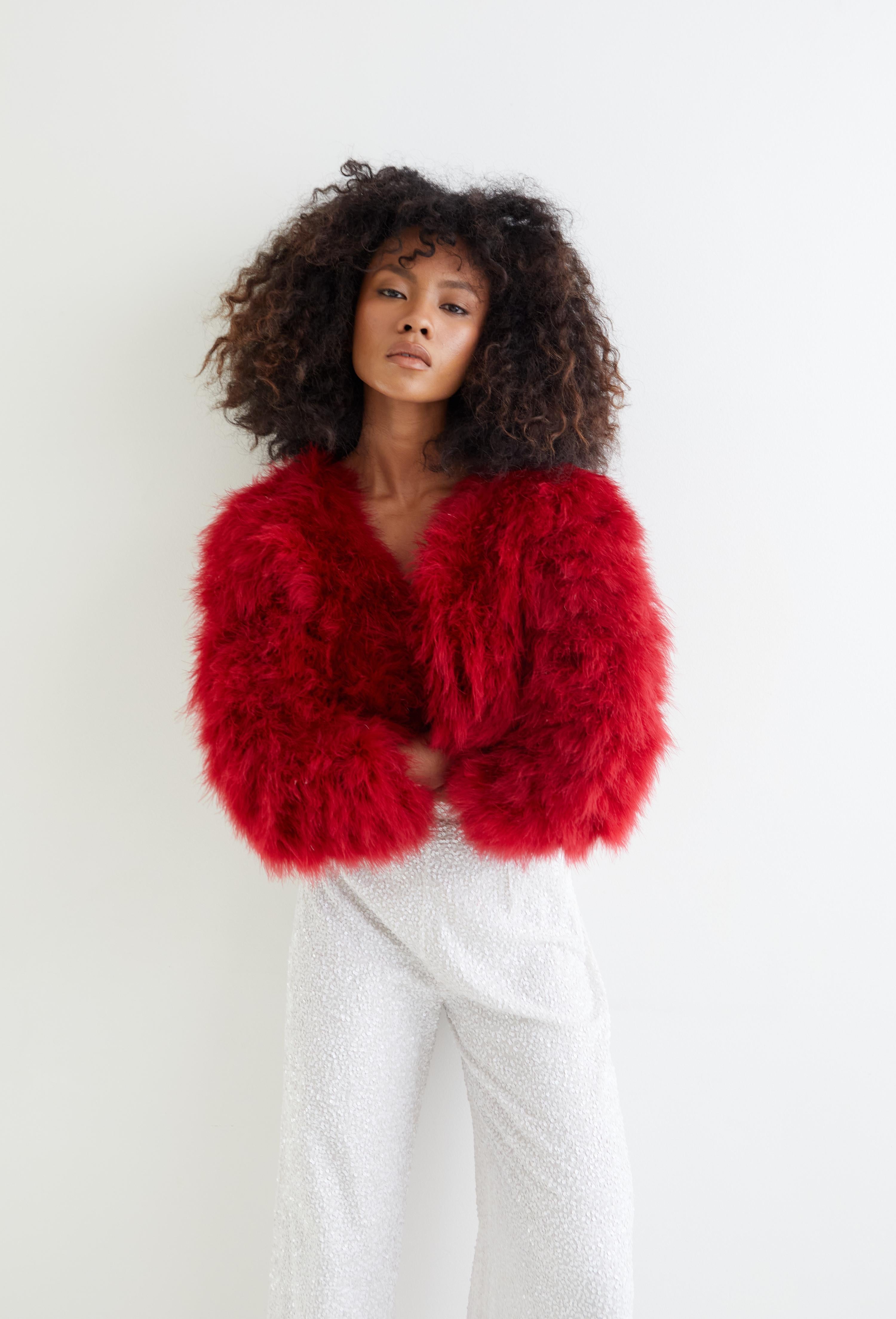 A gorgeous statement piece from French lingerie and ready to wear designer Chantal Thomass, this jacket dates to the F/W 1990 runway collection. Made of hand dyed crimson ostrich feathers which are set onto the base fabric in a twisted fashion to