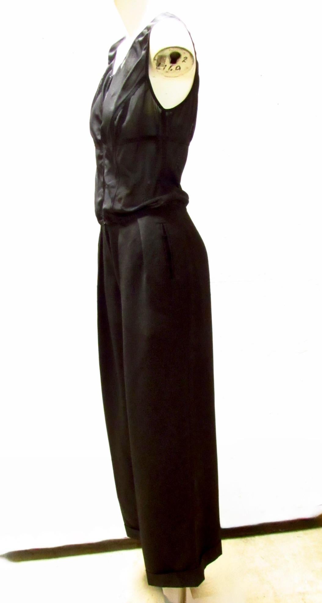 Black, front zippered jumpsuit from vintage Chantal Thomass. The pants are a wool acetate, featuring pockets on the seams and cuffed hems. The zippered bodice is a mesh nylon spandex blend with seams crossing the front and back. 