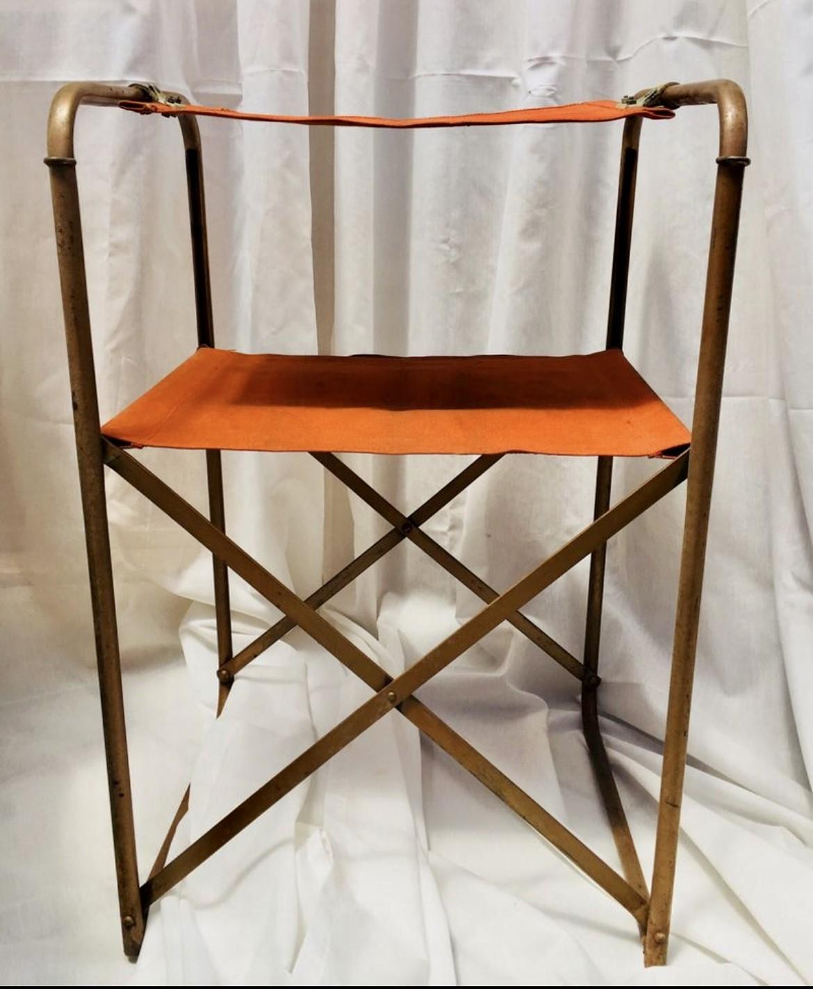 These pair of camping folding chairs called Miss France, were made of brass metal and canvas in orange color and they are a very good example of the old Hollywood style. 
In 1954 the brand Lafuma presented its first line of portable outdoor