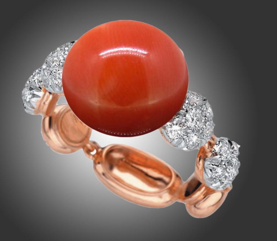 This ring is made by Chantecler and is part of the Capri Bon Bon collection. It is made in 18kt white and pink gold. It is set with 28 round cut diamonds with a total carat weight of approximately 0.70ct. It is set with a vibrant natural red coral