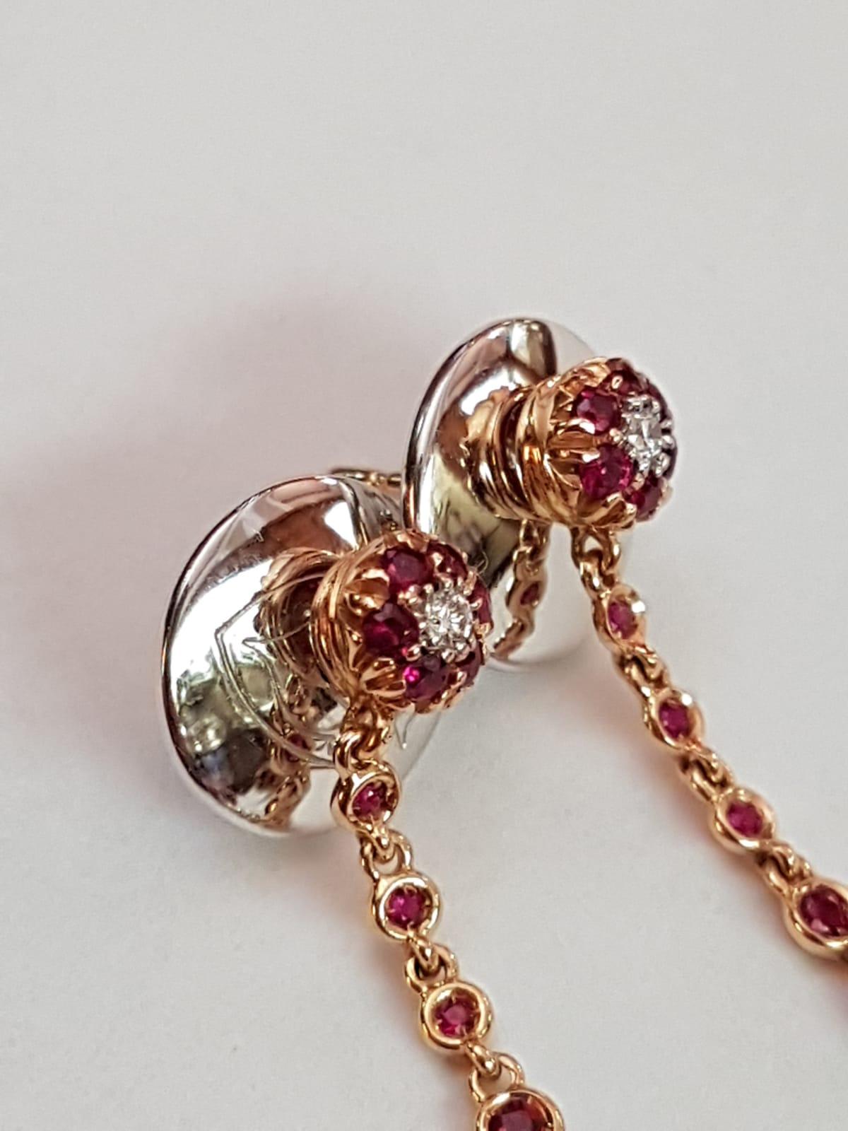 This is an authentic contemporary brand new pair of drop earrings from Chantecler, they are crafted from 18k rose and white gold set with rubies and diamond. It features a round top stud with a sparkling diamond, dangling below from a chain is a