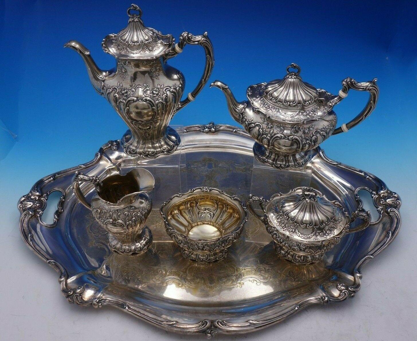 Chantilly by Gorham

Beautiful Chantilly by Gorham sterling silver hand chased 5-piece tea set with silver plate tray. This set includes:

1 - Coffee pot: Measures 9 1/2