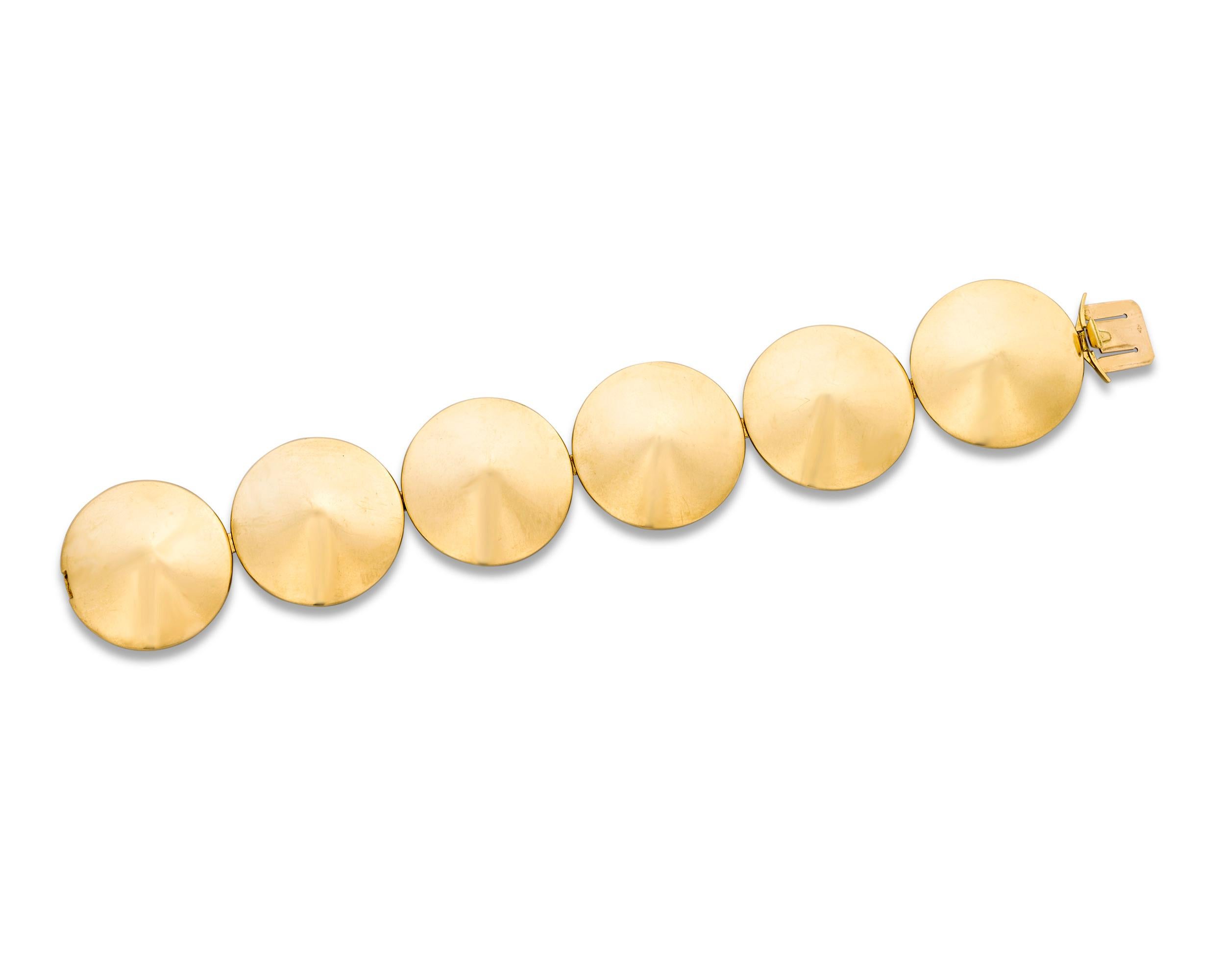 This chic Chapeau Chinois gold link bracelet by Van Cleef & Arpels is a tour-de-force of French jewelry design. Characterized by eye-catching design and grand proportions, the bracelet is composed of large, conical 18K yellow gold discs, providing a