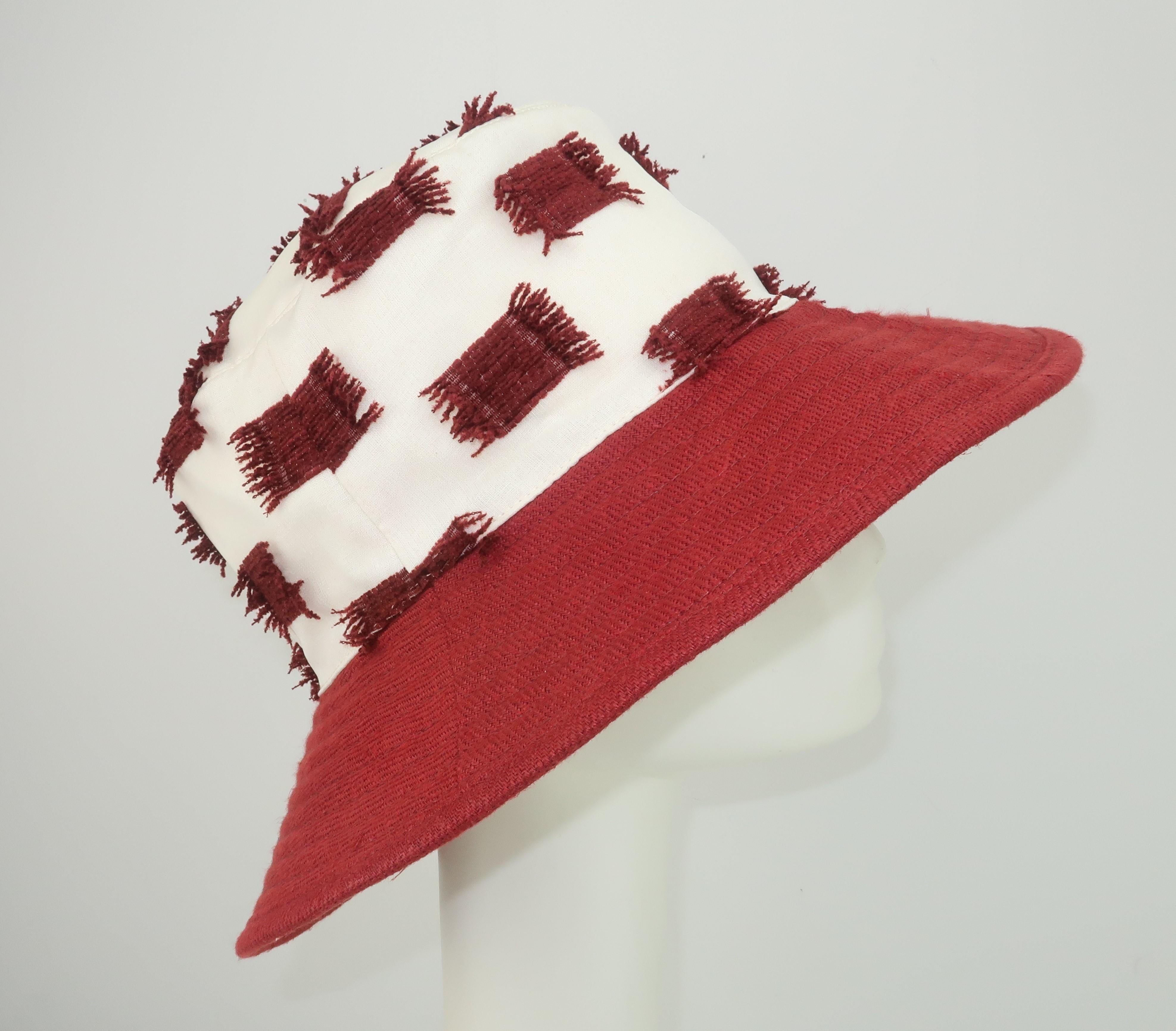 Go casual with Hermès signature style in this comfy bucket hat by Chapeaux Motsch, a famous Parisian hat atelier est. 1887 acquired by Hermès in 1991.  The hat combines texture and fabrics with a brick red brim in acrylic, that looks like wool, and