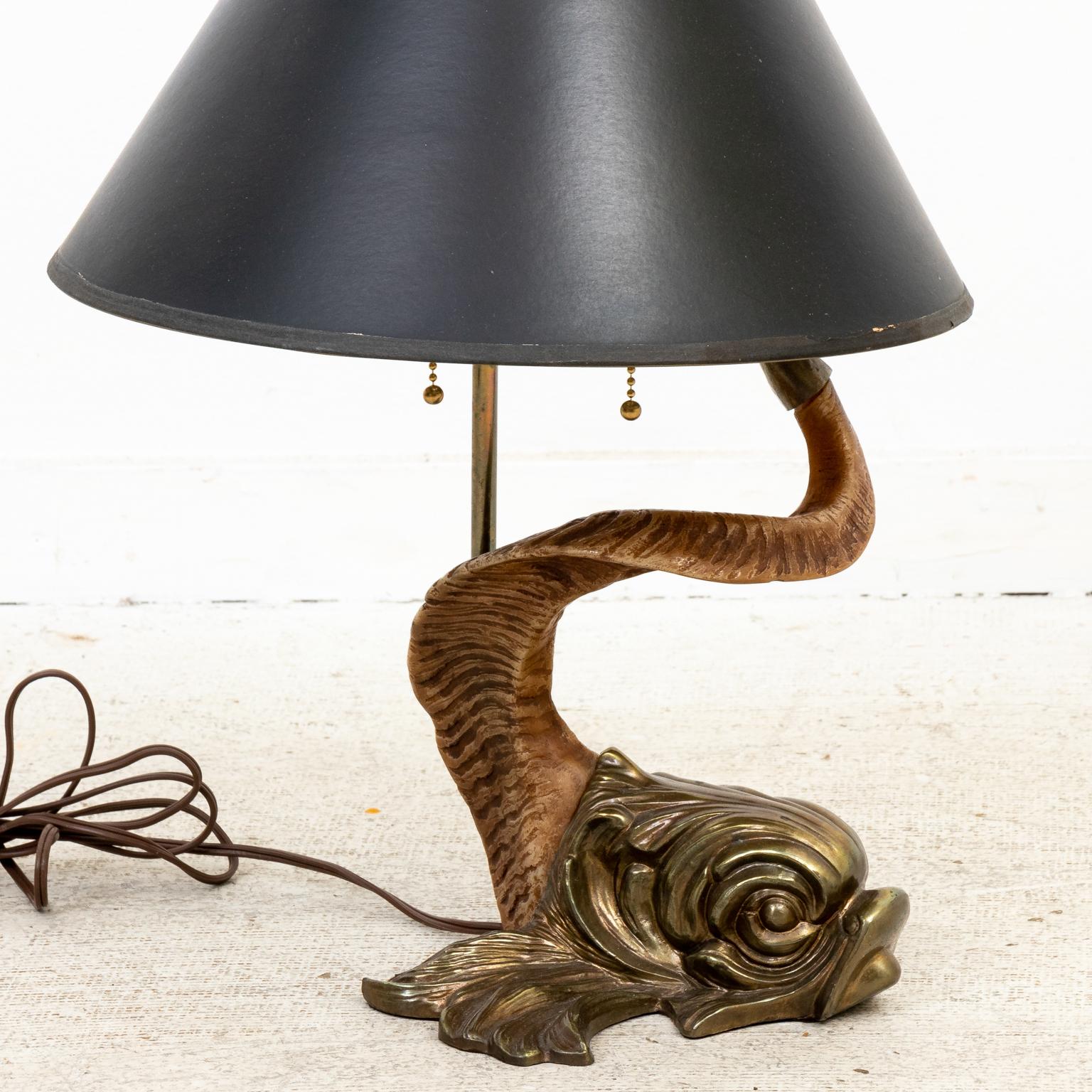 Mid-Century Modern style Brass dolphin lamp with resin tail made in the United States by Chapman in 1977 with original foil lined black shade. The original Chapman label is featured on the socket. Shade included with the date 1977. Please note of