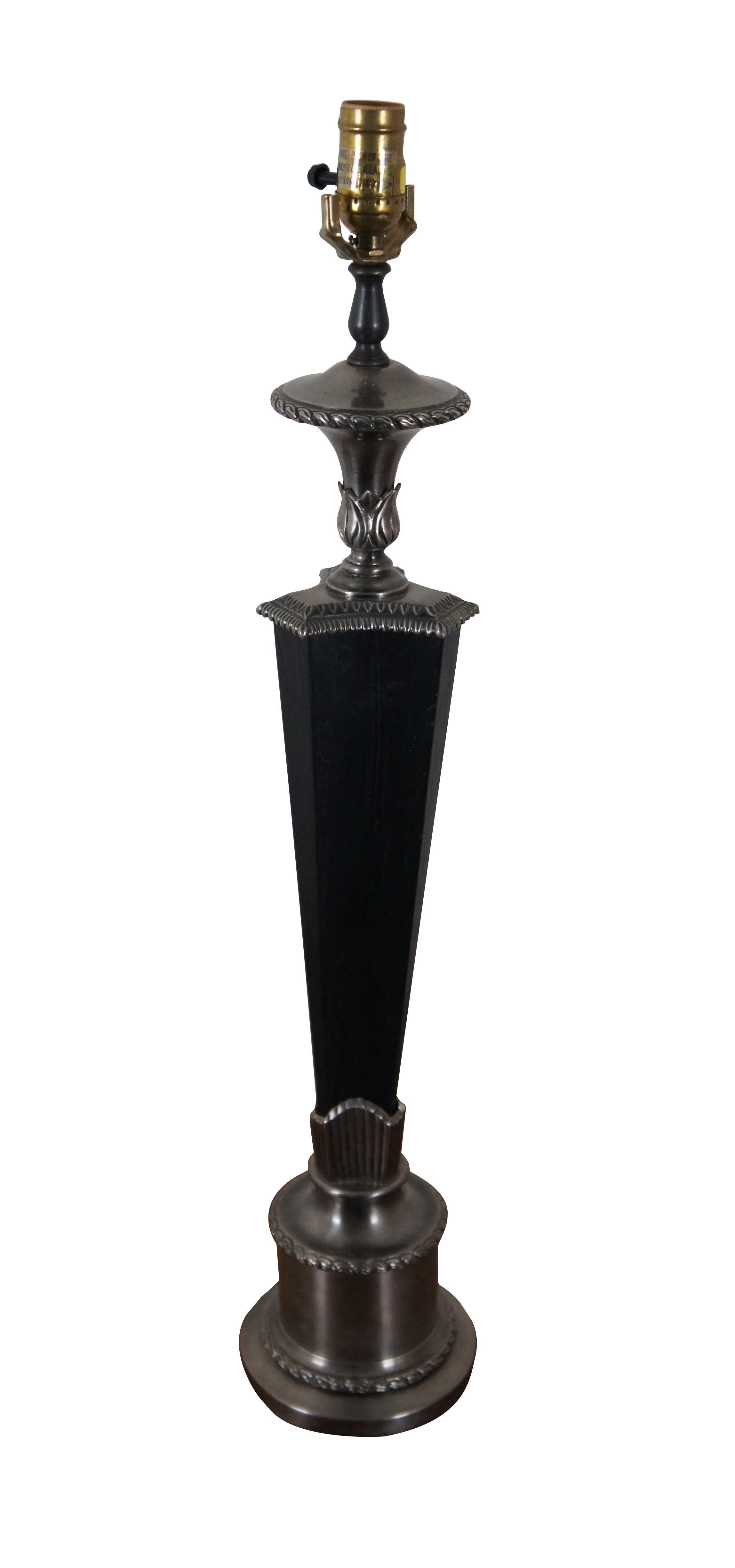 Chapman torchiere / torch shaped table lamp crafted of ebonized wood and brushed silver tone metal, with a round base and triangular body with concave sides. No harp, no shade.  Circa 2000.

DIMENSIONS
6” x 30” (Diameter x Height)
