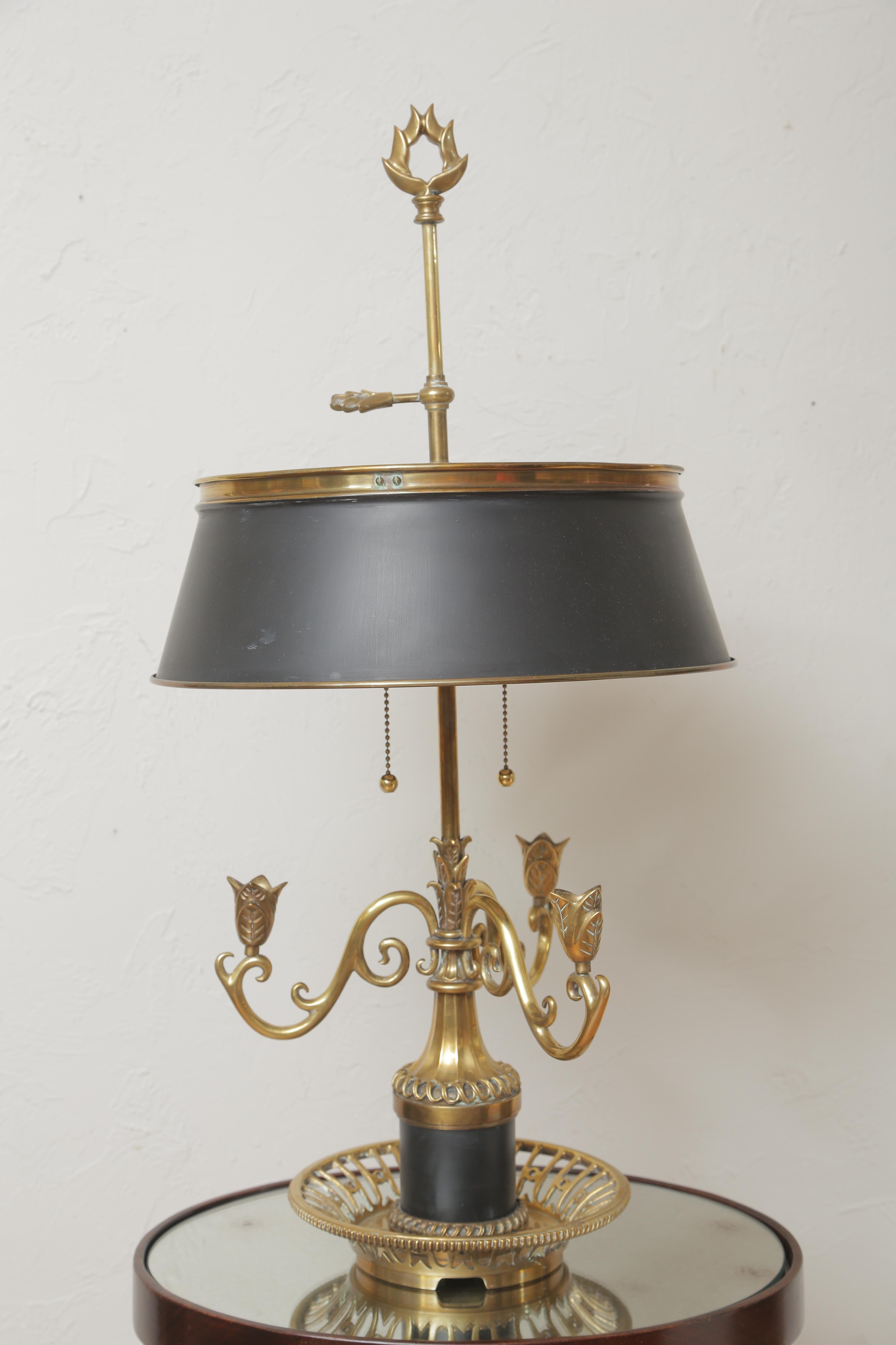 Vintage brass and black tole Bouillotte lamp by Chapman.