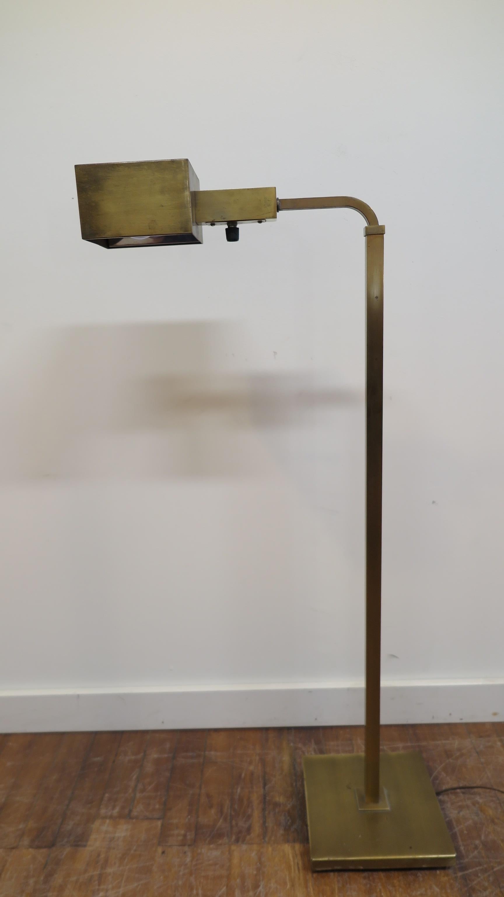 Brass modernist articulating floor lamp by Chapman. The Lamp can adjust height from 42 inches to 65 inches. The shaft turns completely 360 as does the shade, allowing versatile lighting possibilities from reading lamp beside a chair, wall art