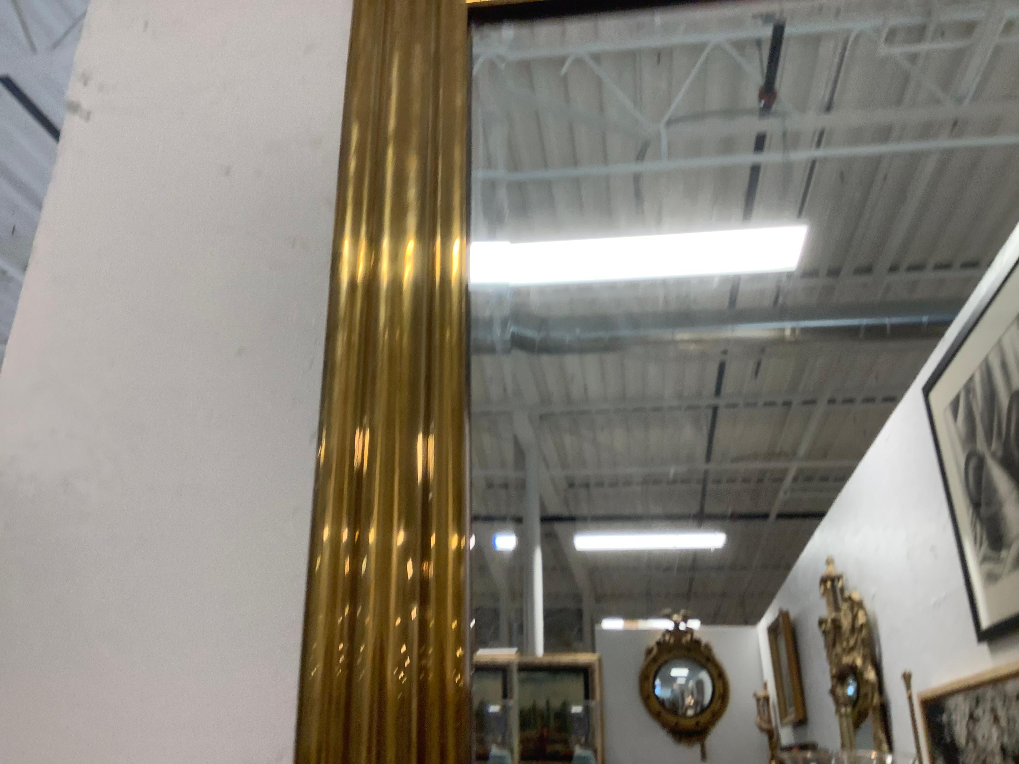 Very handsome, brass framed beveled mirror, by Chapman, dated 1982. I love the simplicity of the frame, and the larger size. Could be used with any number of design styles. 1” Bevel surrounds the mirror.