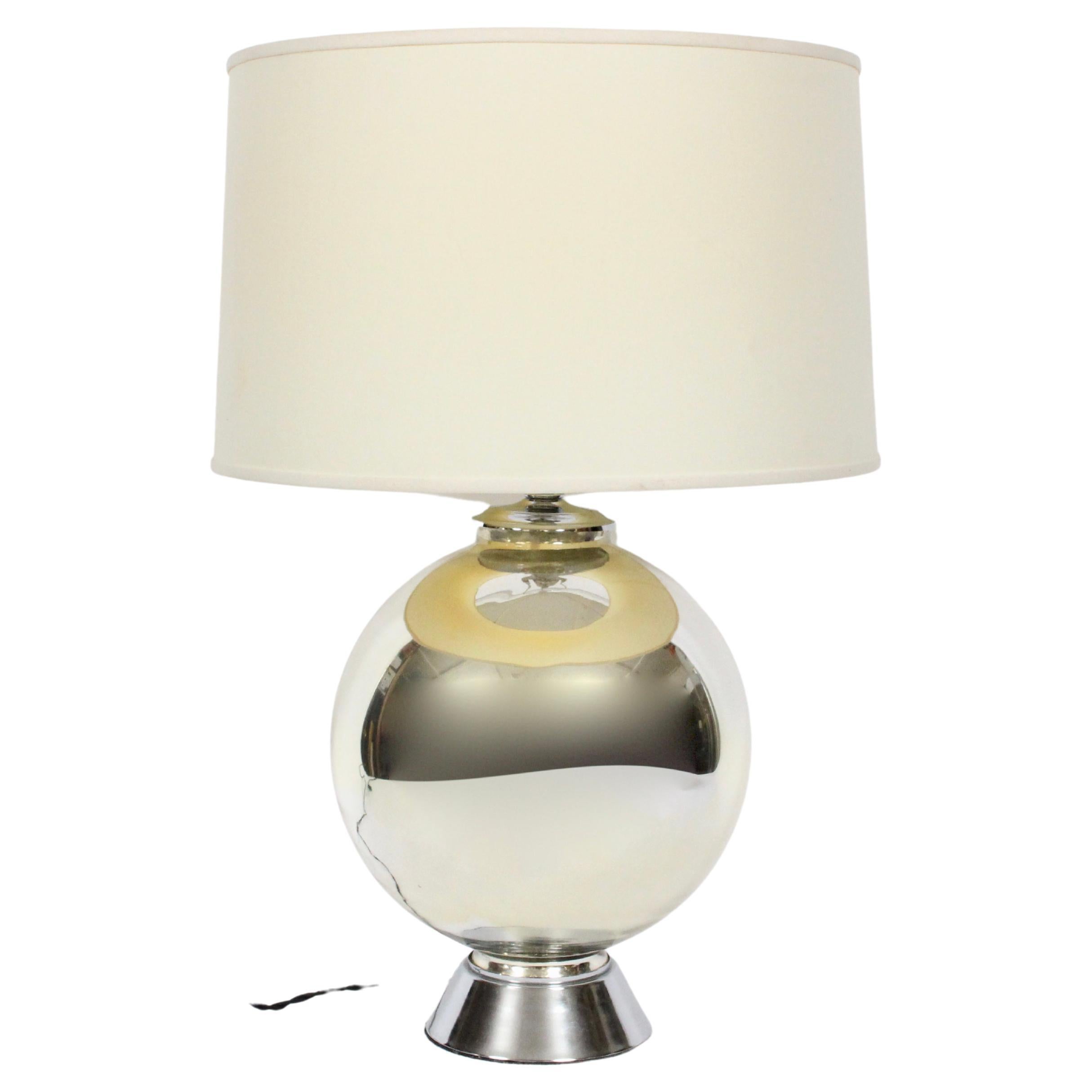 Chapman Manufacturing Co. attributed Mercury glass lamp. Featuring a reflective ball form atop a round, tapered Nickel plated 6D base. Ball 20H to top of socket. Shade shown for display only and not for sale (11 H x 17 D top x 18 D bottom). Bedside.