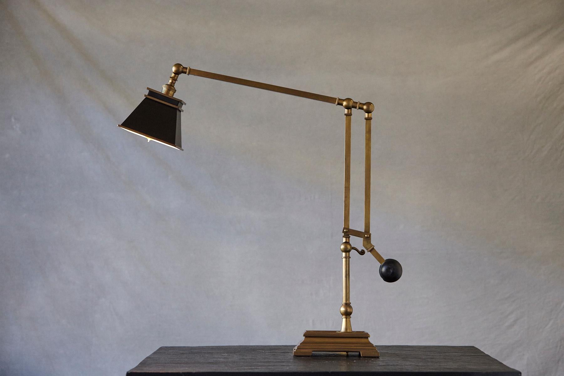 E.F. Chapman engravers weight balanced desk lamp in burnished brass with a square black shade by Visual Comfort & Co.

A solid desk lamp in excellent brass quality and finish, with a heavy black iron counter weight.
The little knob for the dimmer