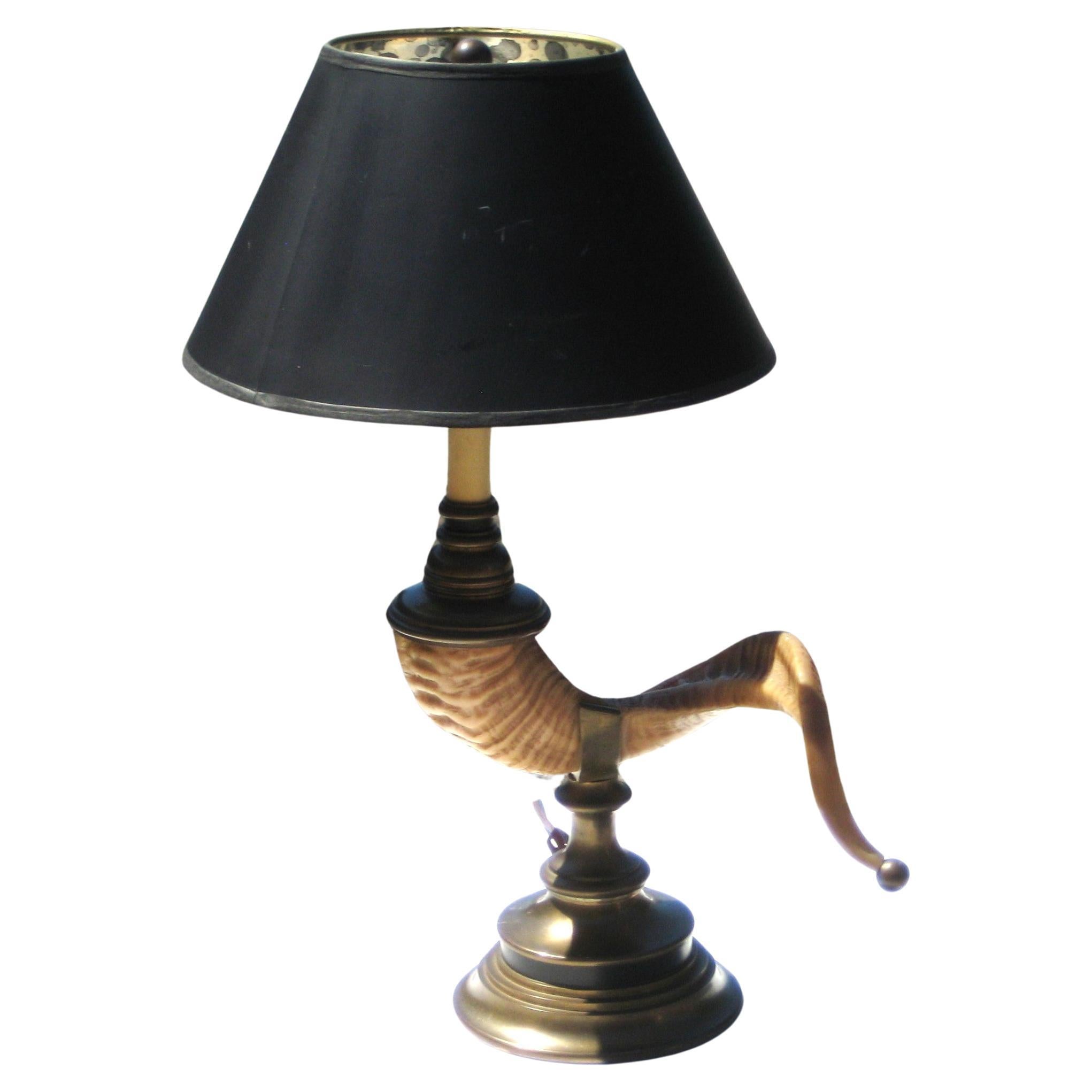  Cast resin faux ram's horn table lamp w/ brass base and the original black paper shade w/ marbleized silver metallic interior. Chapman, circa 1970's. Measures 10