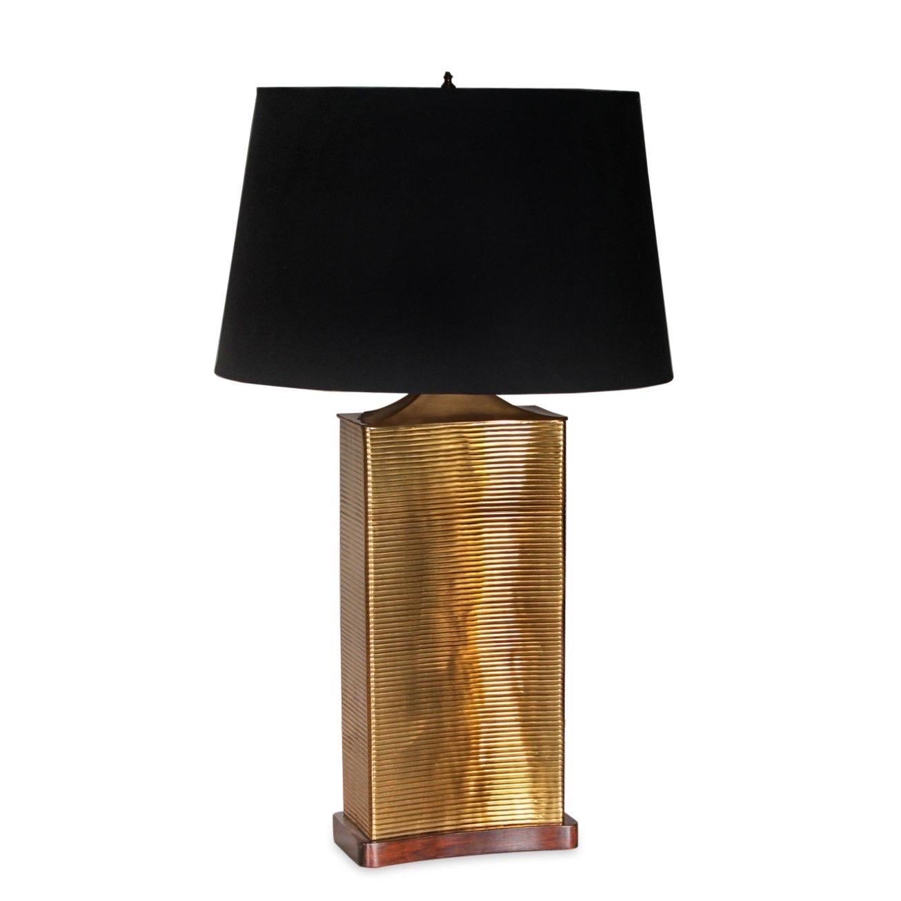 Frederick Cooper uptown brass table lamp, circa 2000.

Features ribbed body in antique brass finish, walnut base and a black silkette shade.

Dimensions with shade: 14”L x 14”W x 29”H 
Base: 8.5”L x 4.5”W.

