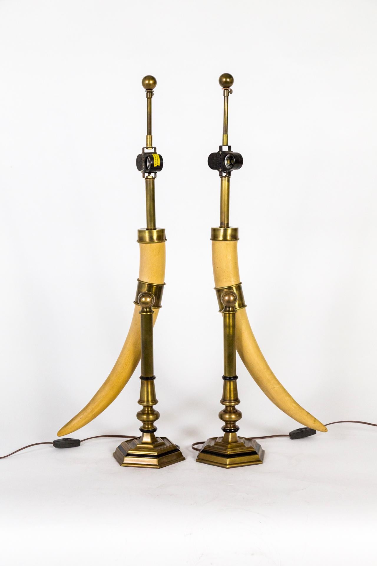 A pair of tall table lamps by Chapman, featuring large, faux horns on brass stands; with brass caps and finials. A very refined look. Made in 1975, USA. Double sockets, newly rewired with in-line switches. 31-33