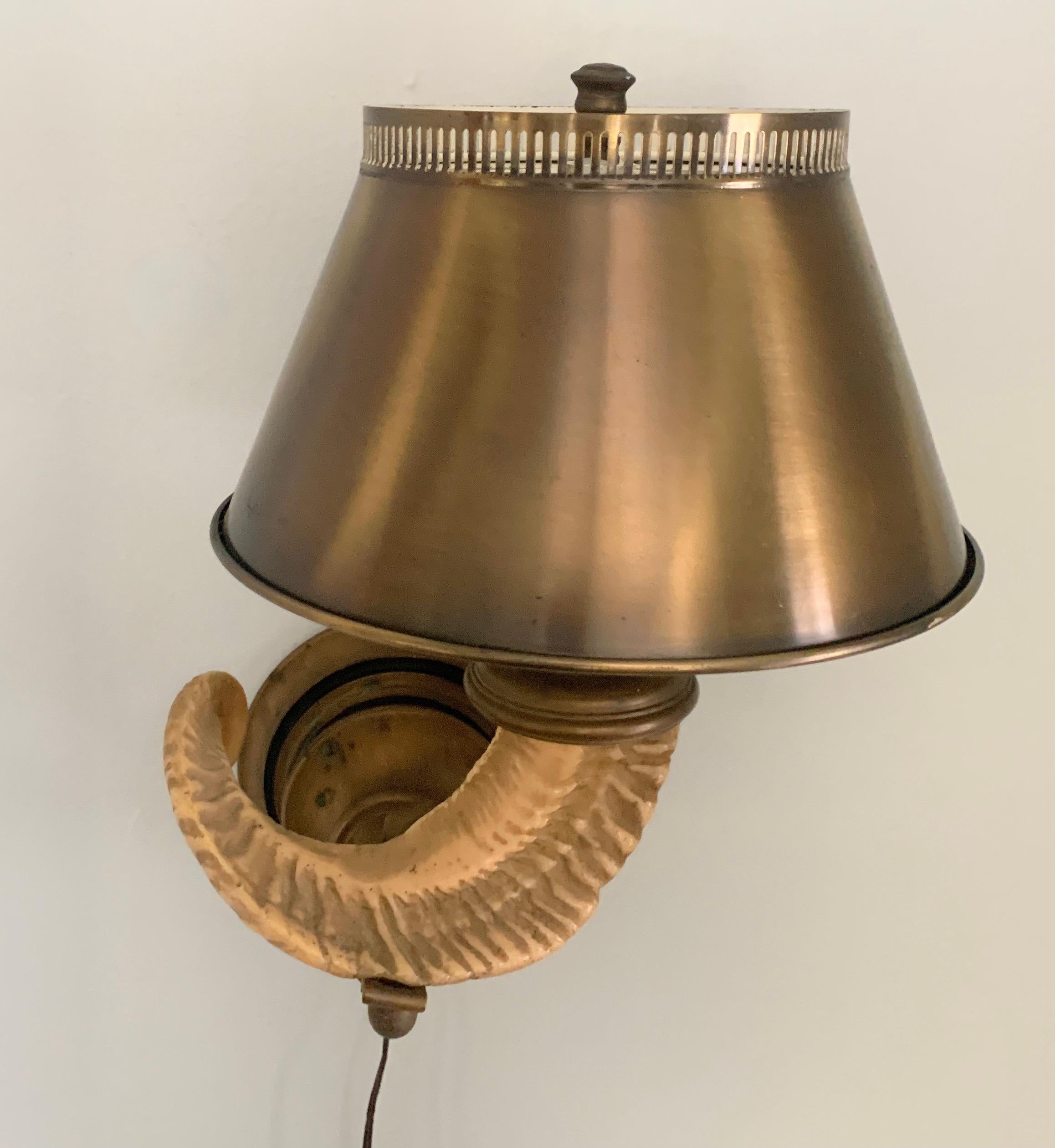Wall Sconce by Mid Century lamp Aficionado, Chapman. The Sconce features an Antler or Horn with metal shade and finial for light diffusion. The metal is patinated and in good condition. A compliment to any interior and especially those with a rustic