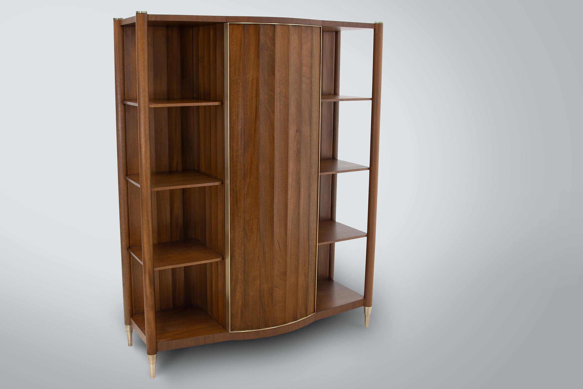 Our Landon Bookcase in scalloped Honduran Mahogany with hand rubbed oil finish and patinated brass accents.