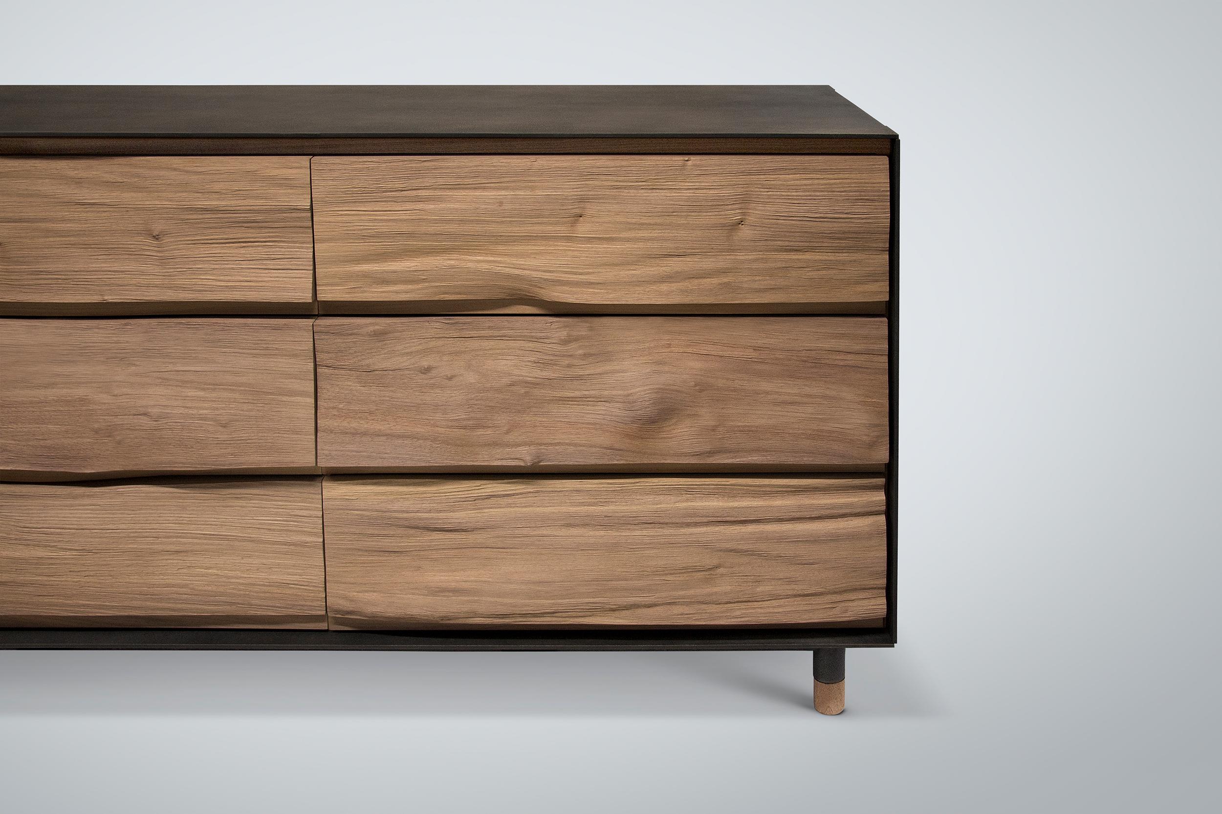 Our split walnut dresser features American black walnut drawer faces and a steel cladding surround that's textured with a mottled acid-etched pattern and finished with Japanese brown patina. The dresser rests on a welded steel base with matching