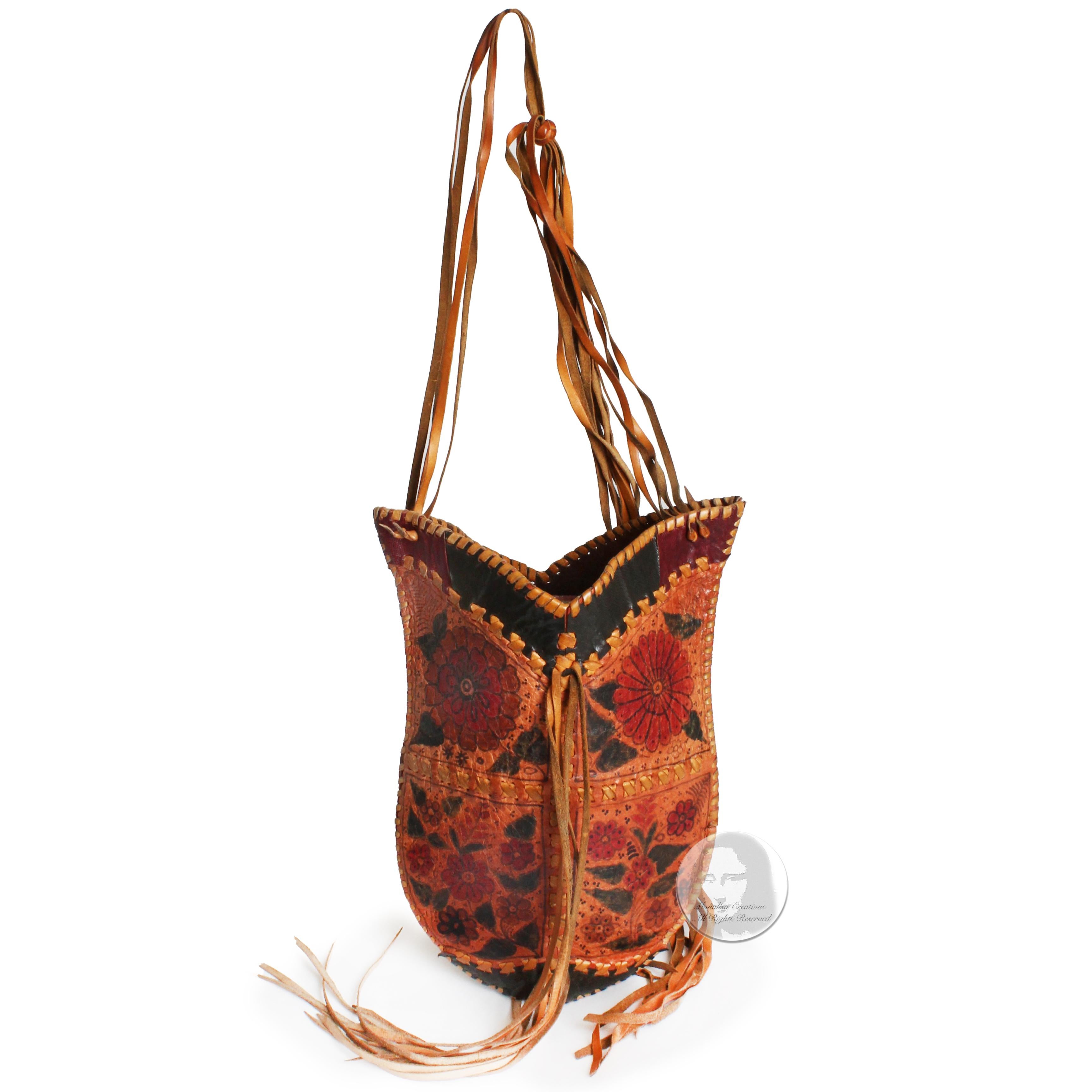 Fabulous, unique vintage Char Leather whipstitch shoulder bag with reptile skin inserts, long fringe & hand painted florals, likely made in the early 70s.  Unlined without closure.  Very rare style and color way, and so hard to find nowadays,