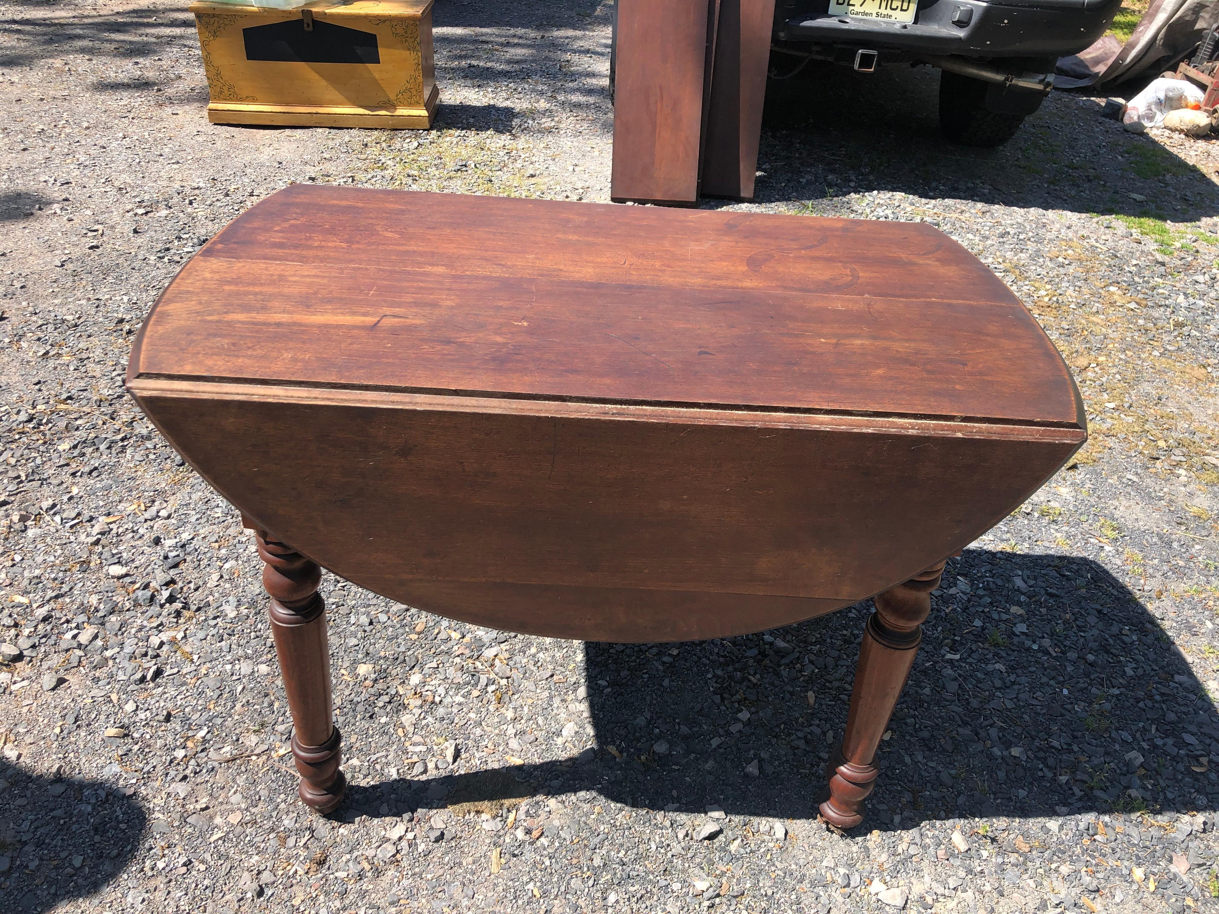 A very versatile much loved antique wooden drop leaf dining table having handsome turned legs and 3 functional shapes:
Drop leaf with leaves down, rectangular: 41.25 L x 24 D x 27 H
With leaves extended, not quite round: 47.5 L x 41.25 D x 27