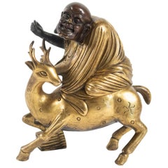 Character Riding a Dain with a Paw Resting on Books, Gilt Bronze and Patina