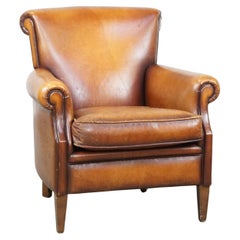 Characterful and comfortable cognac-colored vintage sheepskin leather armchair
