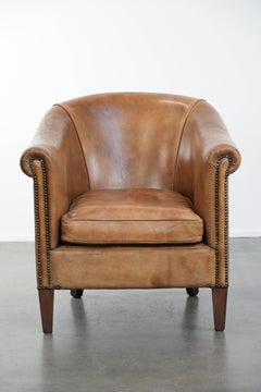 Characterful club chair made of sheepskin leather with light cognac colours